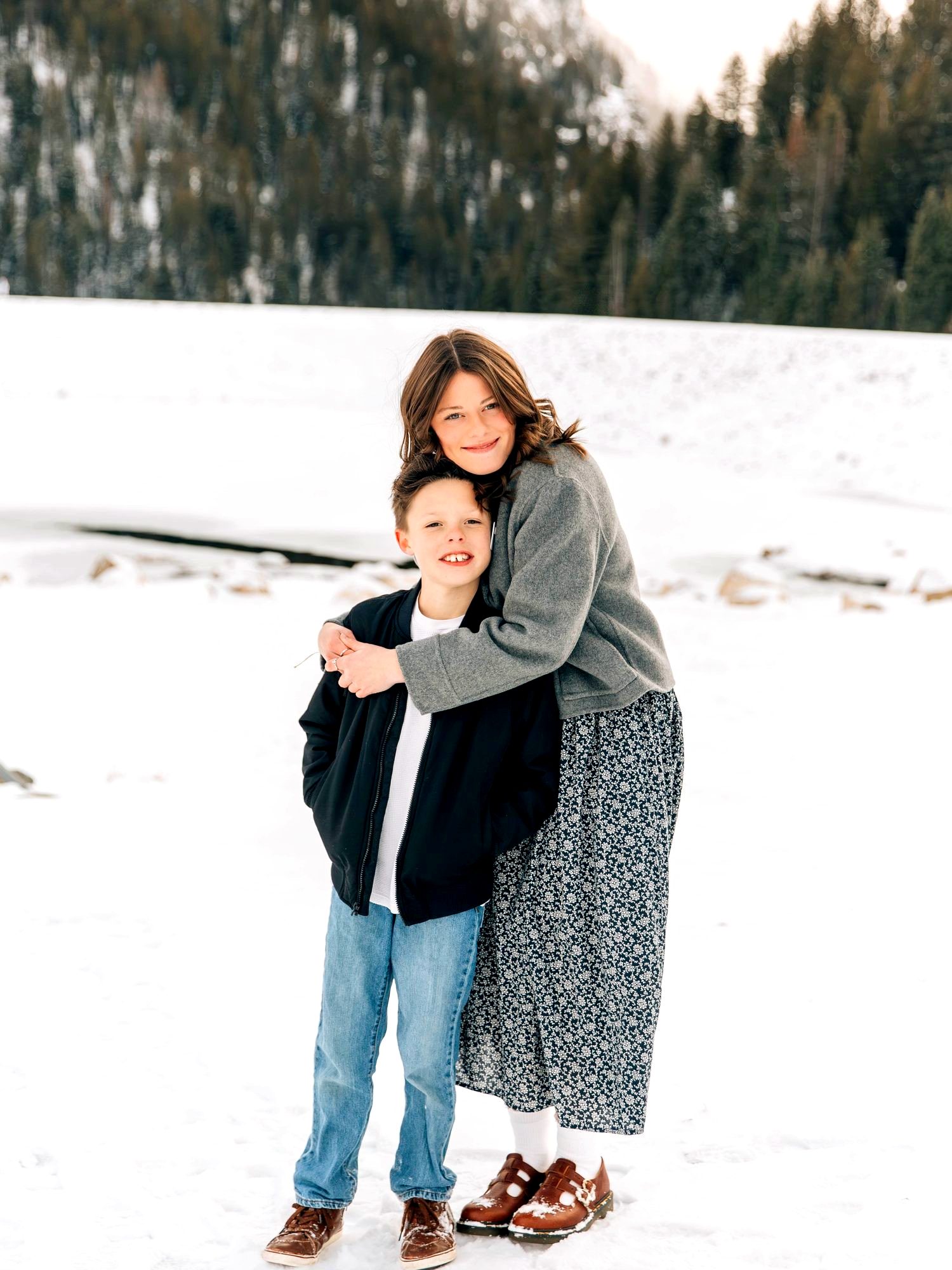 Amy hugging two of the kids in the snow