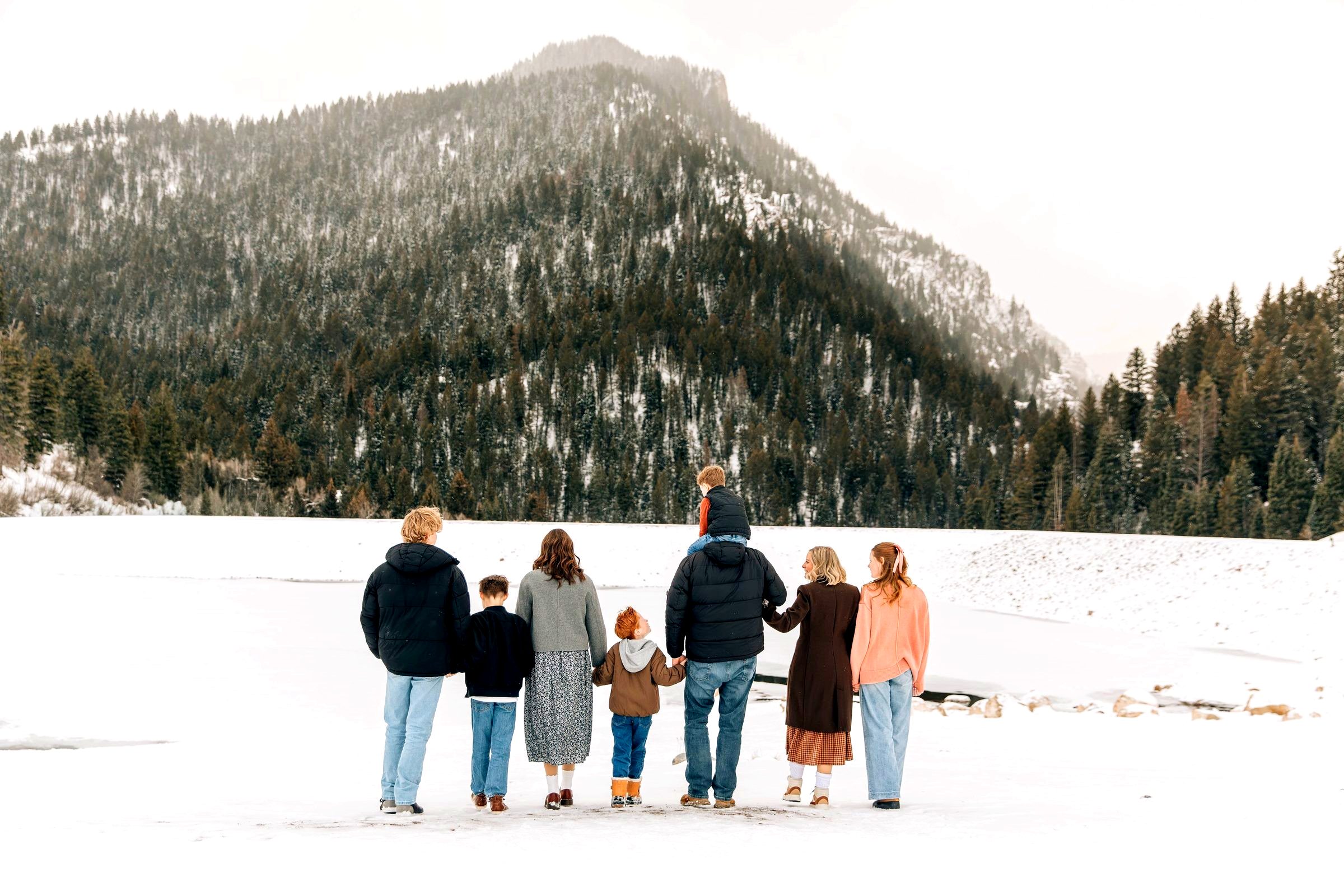 The O'Neal family, all eight of us, standing together in the snow looking up at the mountain