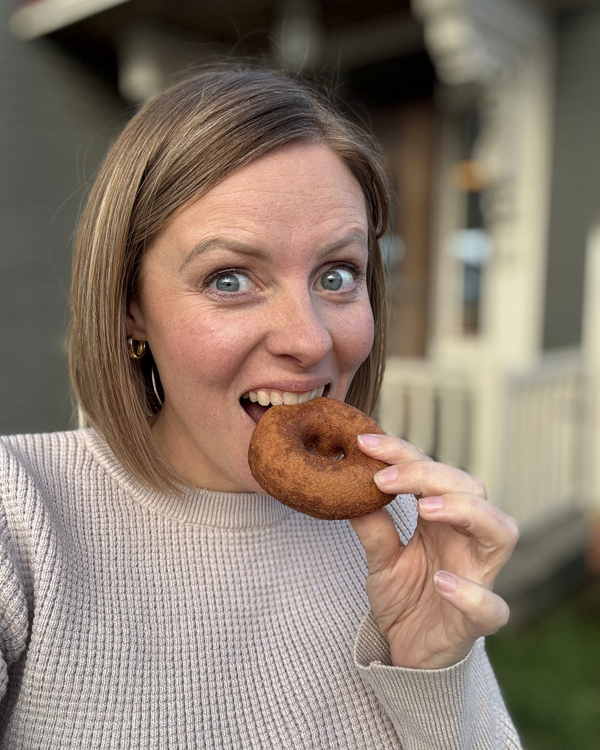 Amy biting into a Cold Hollow apple cider donut