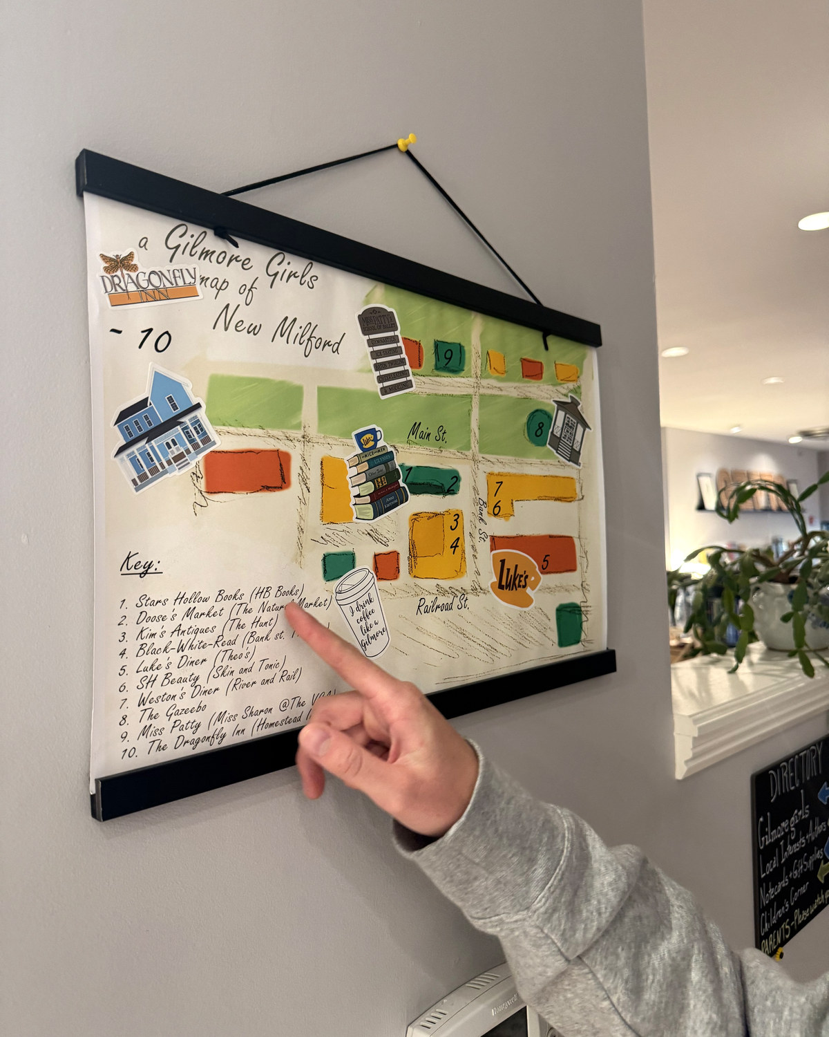 One of the kids pointing at a hand drawn map of the Gilmore Girls spots around New Milford
