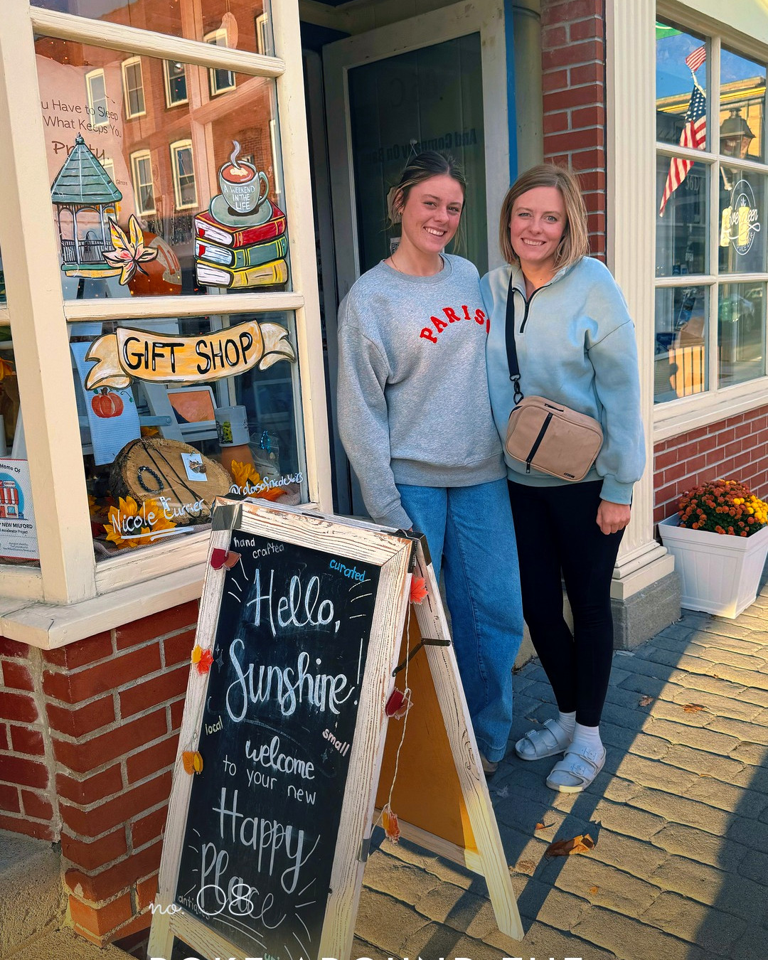 Amy and one of the girls outside a gift shop in New Milford, a Hello Sunshine chalkboard on the sidewalk