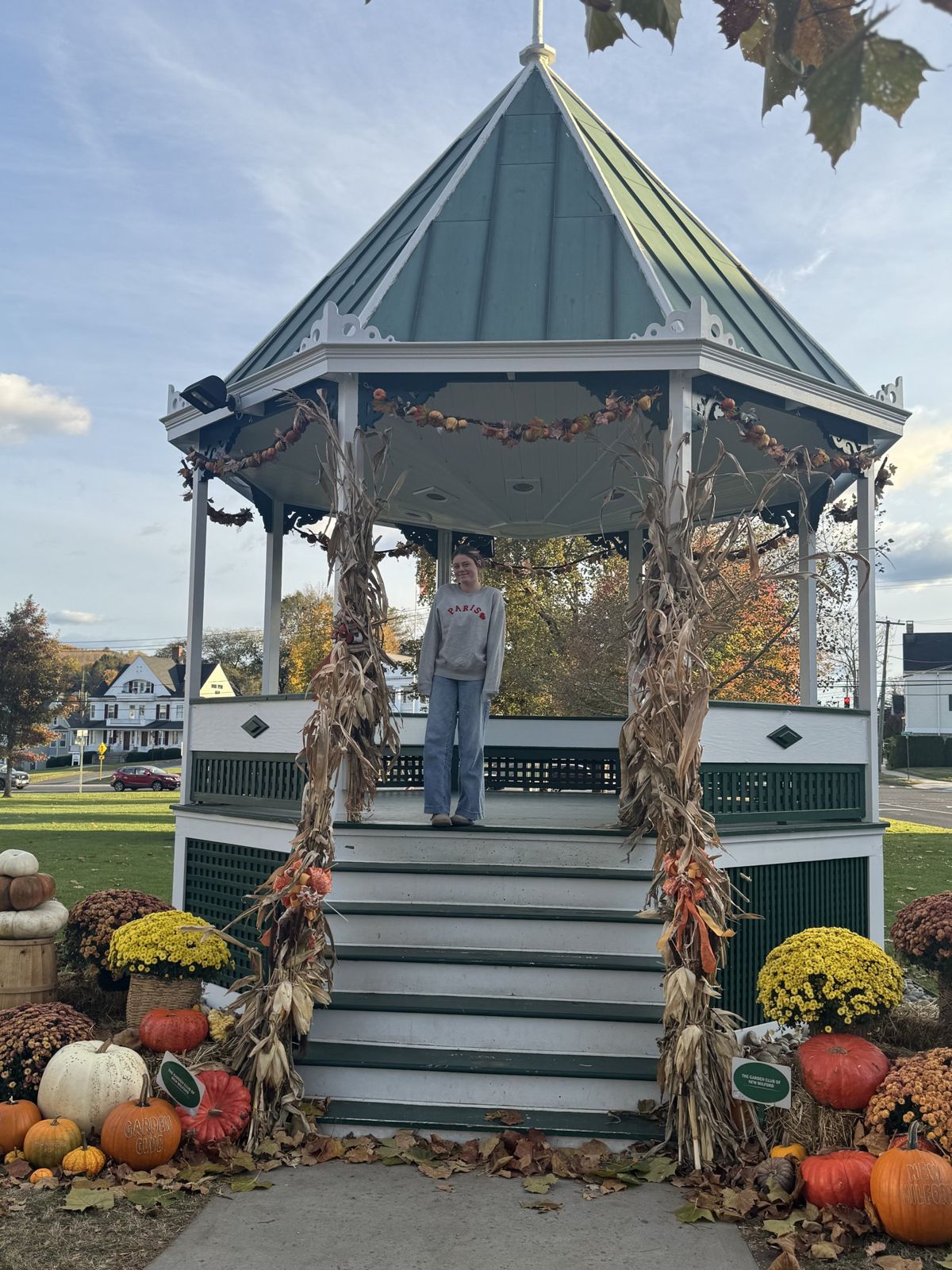 The New Milford bandstand wrapped in corn stalks with mums and pumpkins