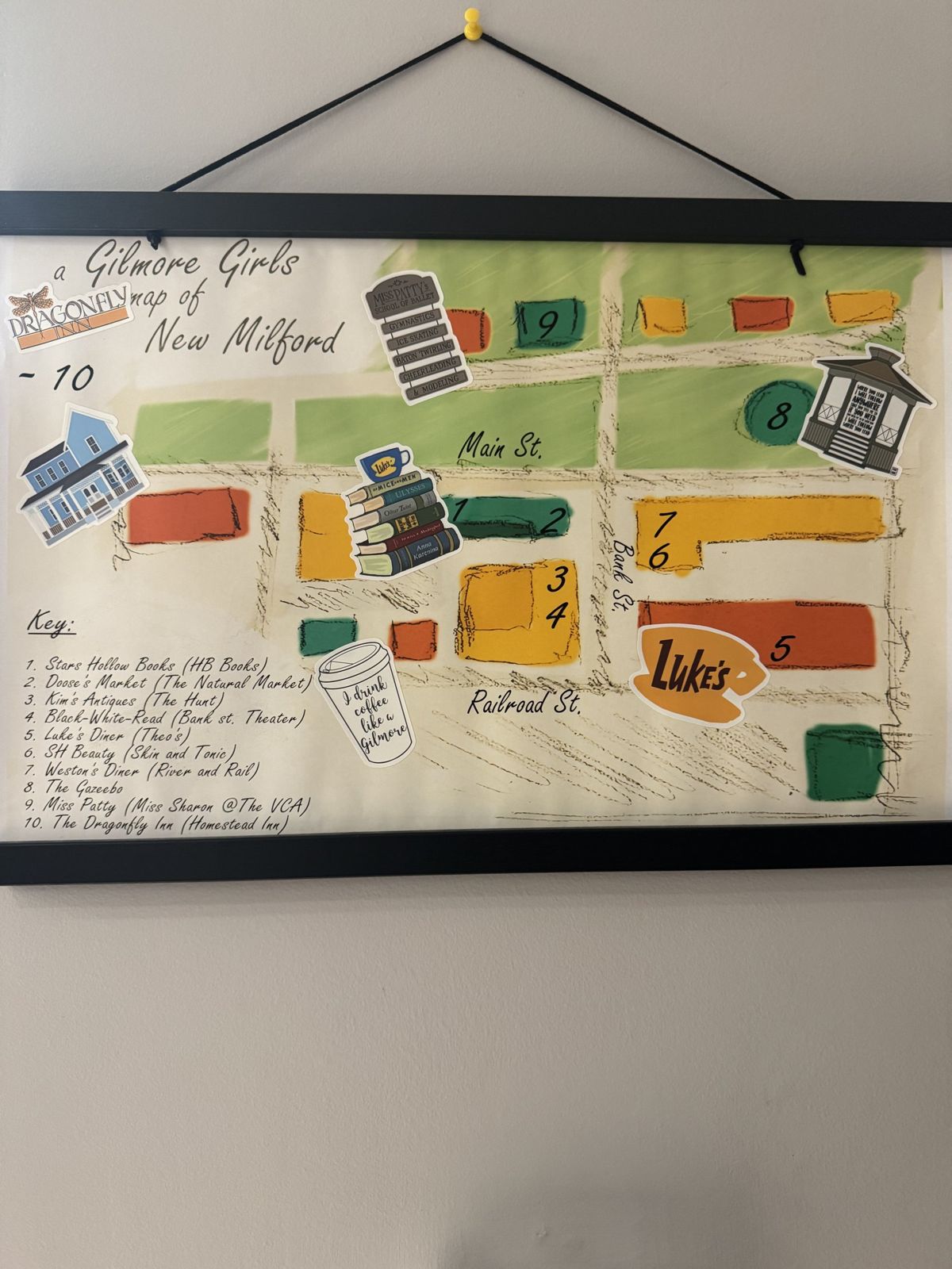 A hand-drawn map of New Milford on the wall at Honeybee Books matching the show's town to the real one