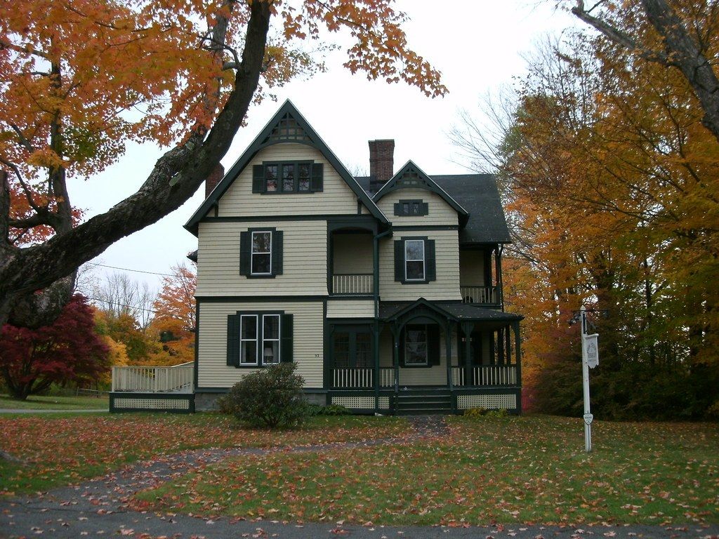 A Victorian house in Litchfield, Connecticut with fall leaves