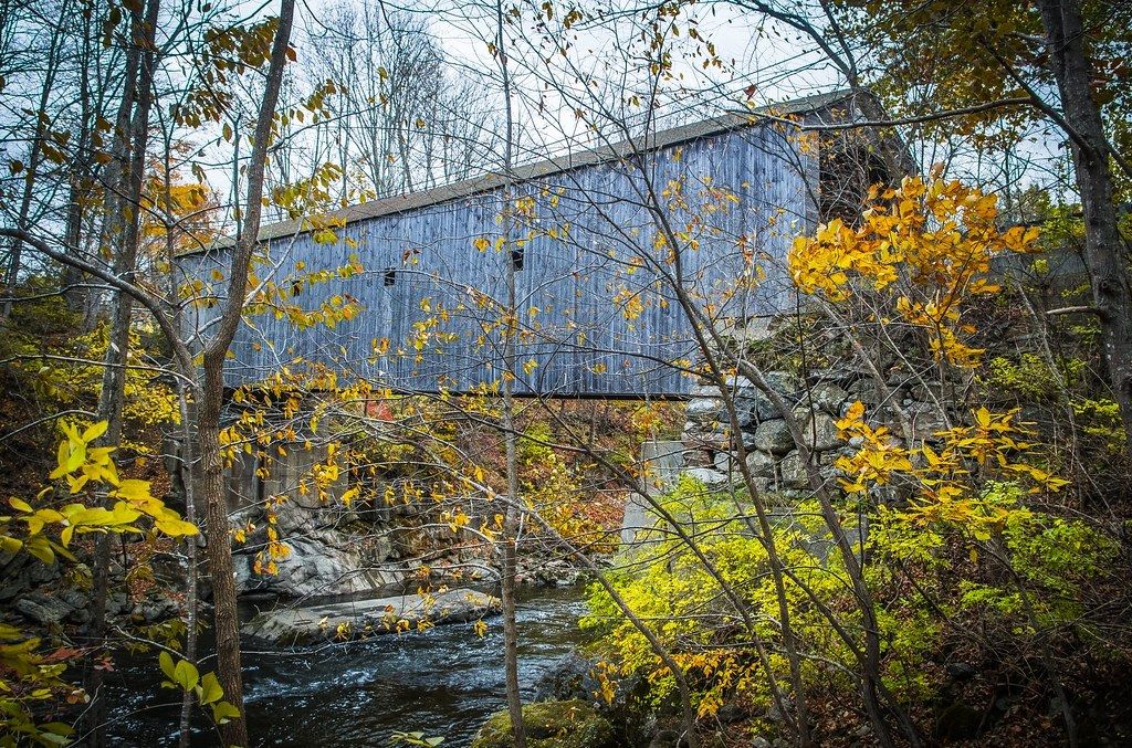 Inside Bull's Bridge, a covered bridge in Kent, Connecticut, with fall leaves