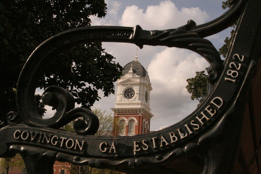 A Covington GA Established 1822 bench framing the clock tower