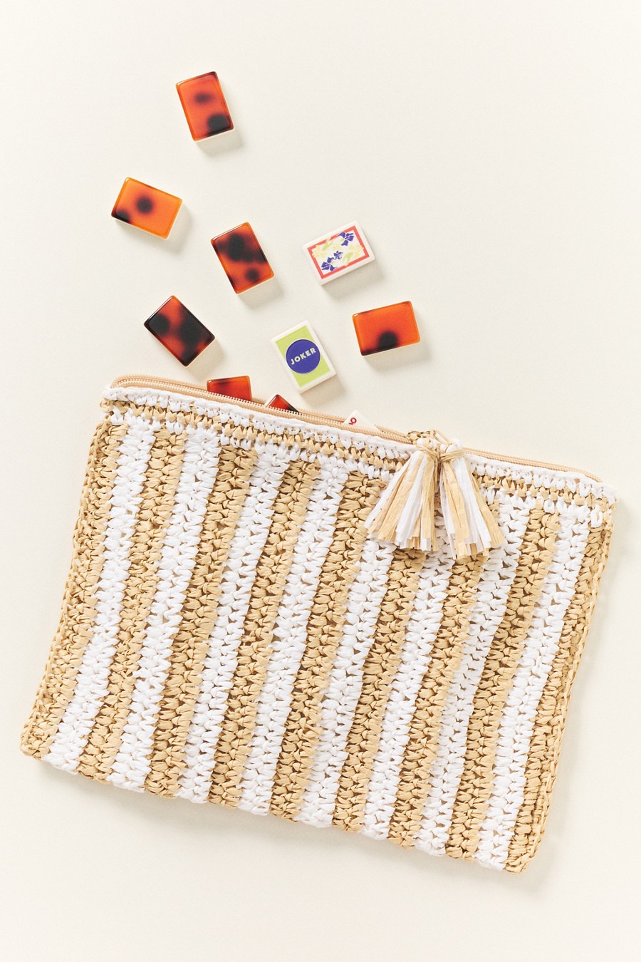 Mahjong tiles spilling from a woven pouch