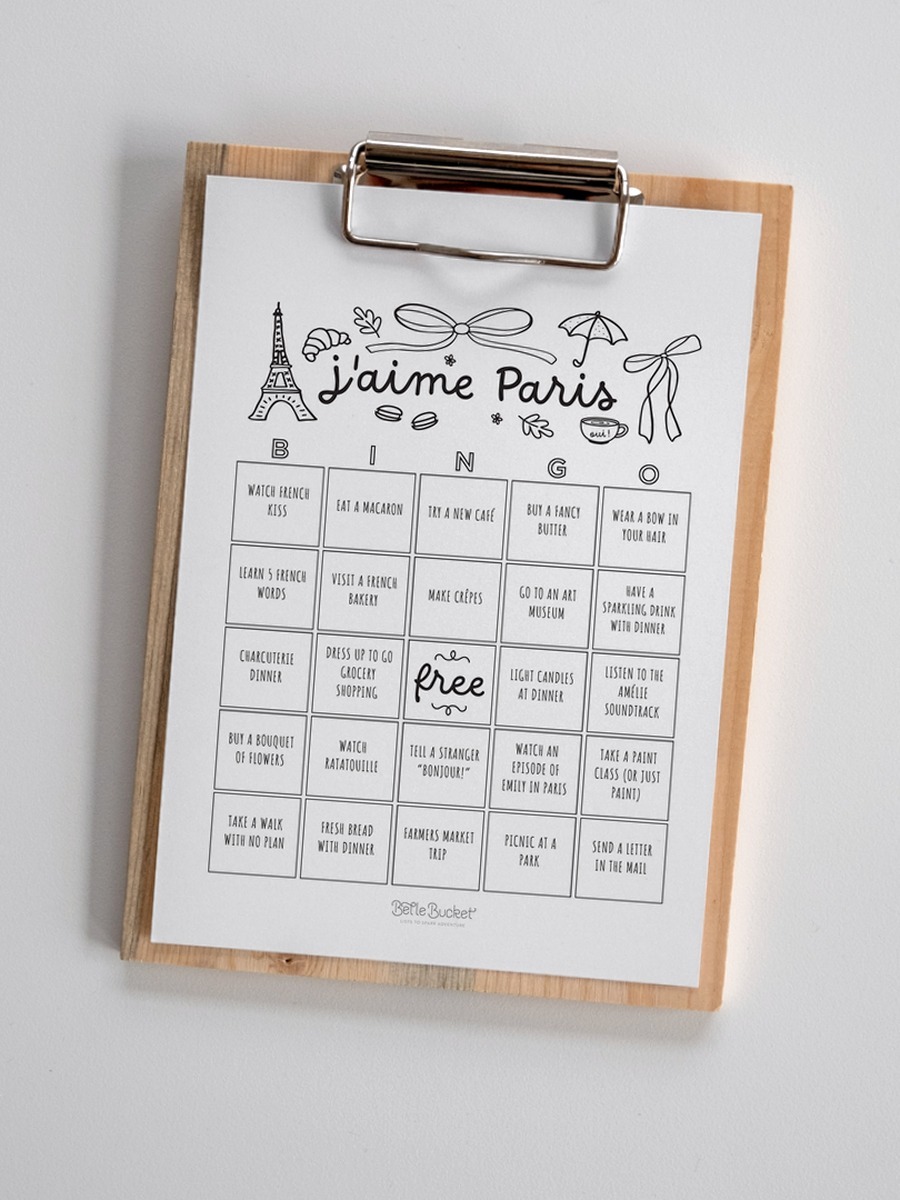 j'aime Paris bingo card held up in front of a pink door