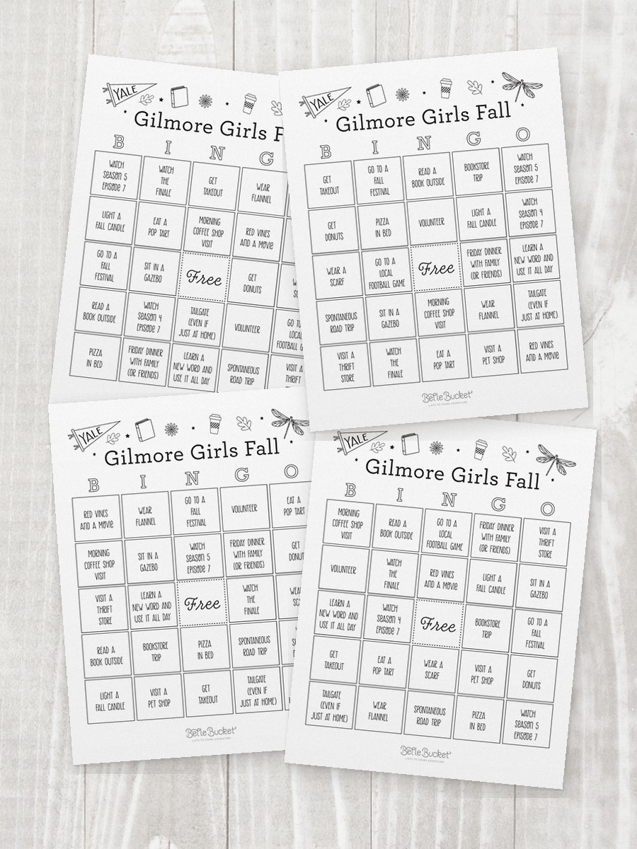 Four shuffled Gilmore Girls Fall bingo cards overlapping on a table, each with the squares in a different order
