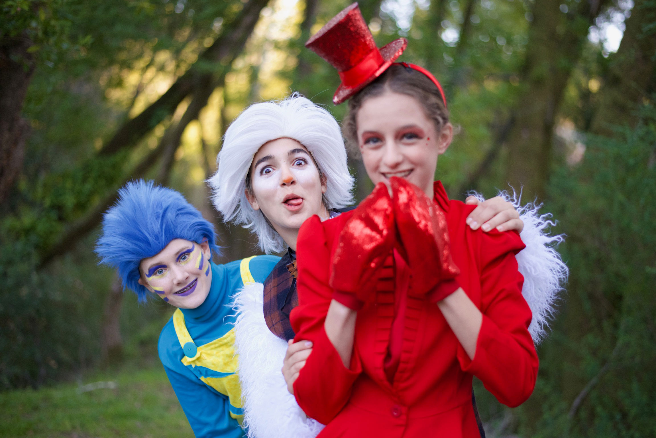 Promotional image for Disney's The Little Mermaid Jr. featuring two performers in mermaid-themed costumes against a blue underwater background with coral and fish illustrations.