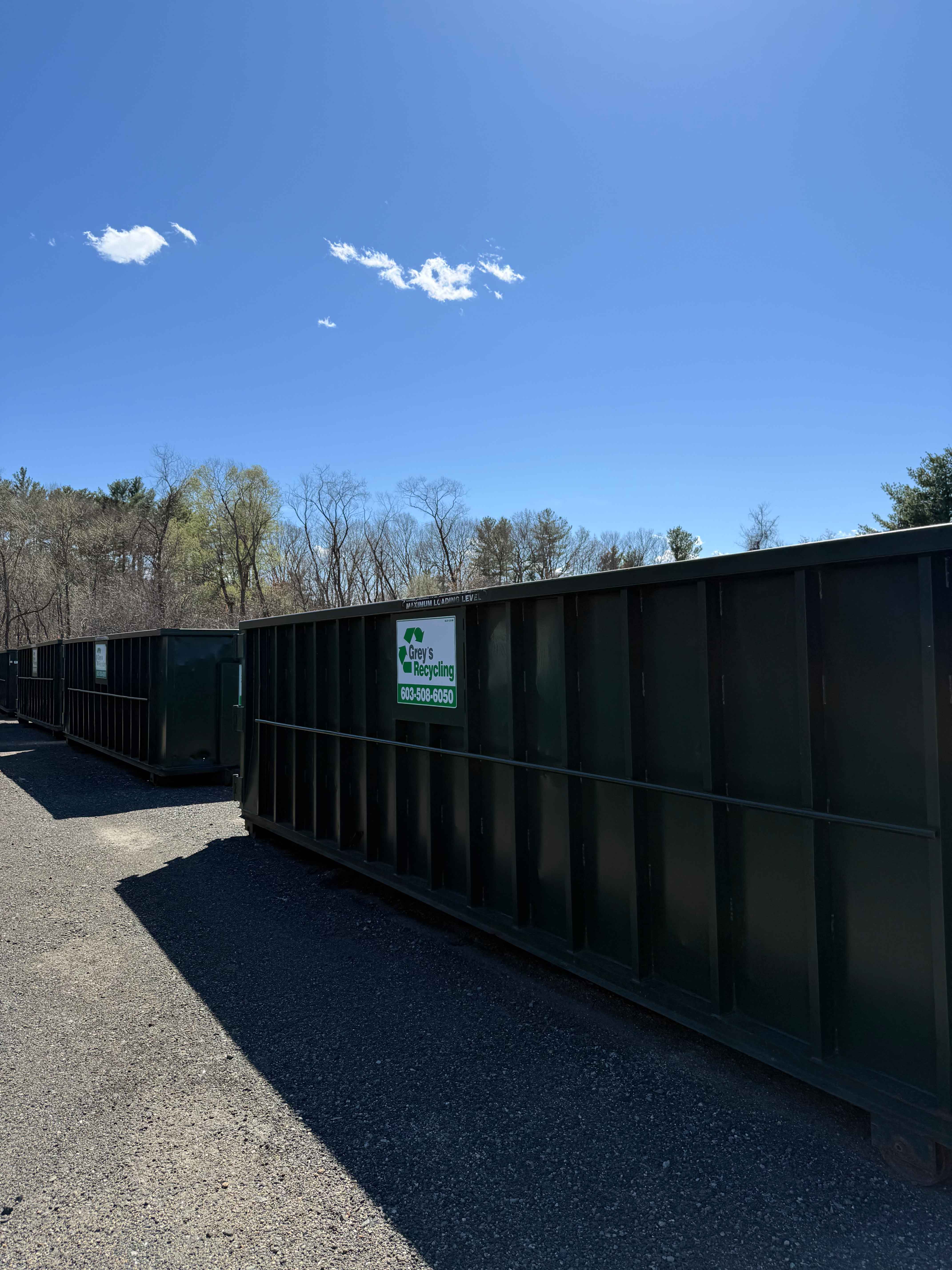 Green roll-off dumpster used for responsible waste disposal