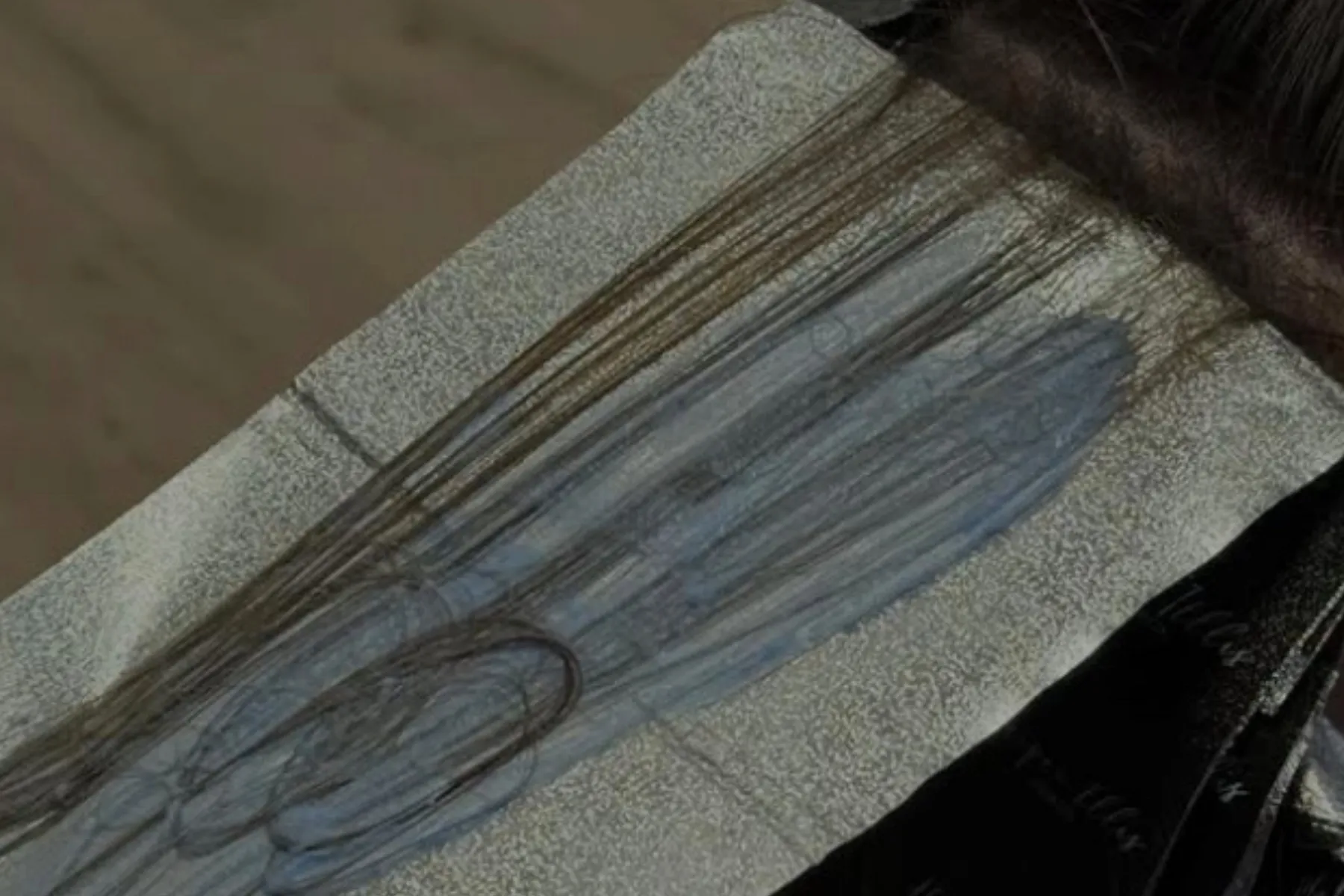 Long strands of wet hair highlighted.