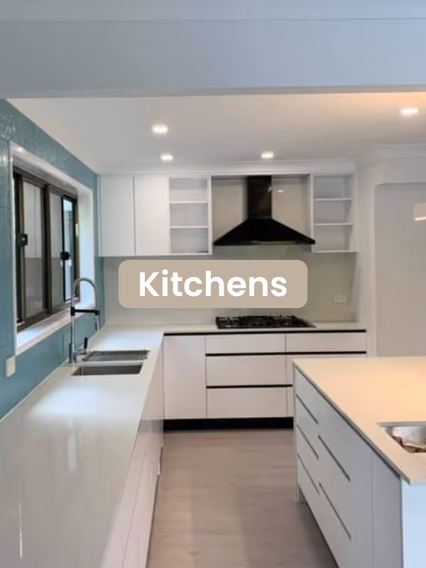 Modern kitchen with white cabinetry, a large island, black range hood, and a window over the sink.