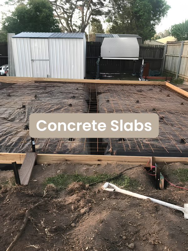 Construction site with wooden framing and wire mesh set for concrete slabs in a backyard.