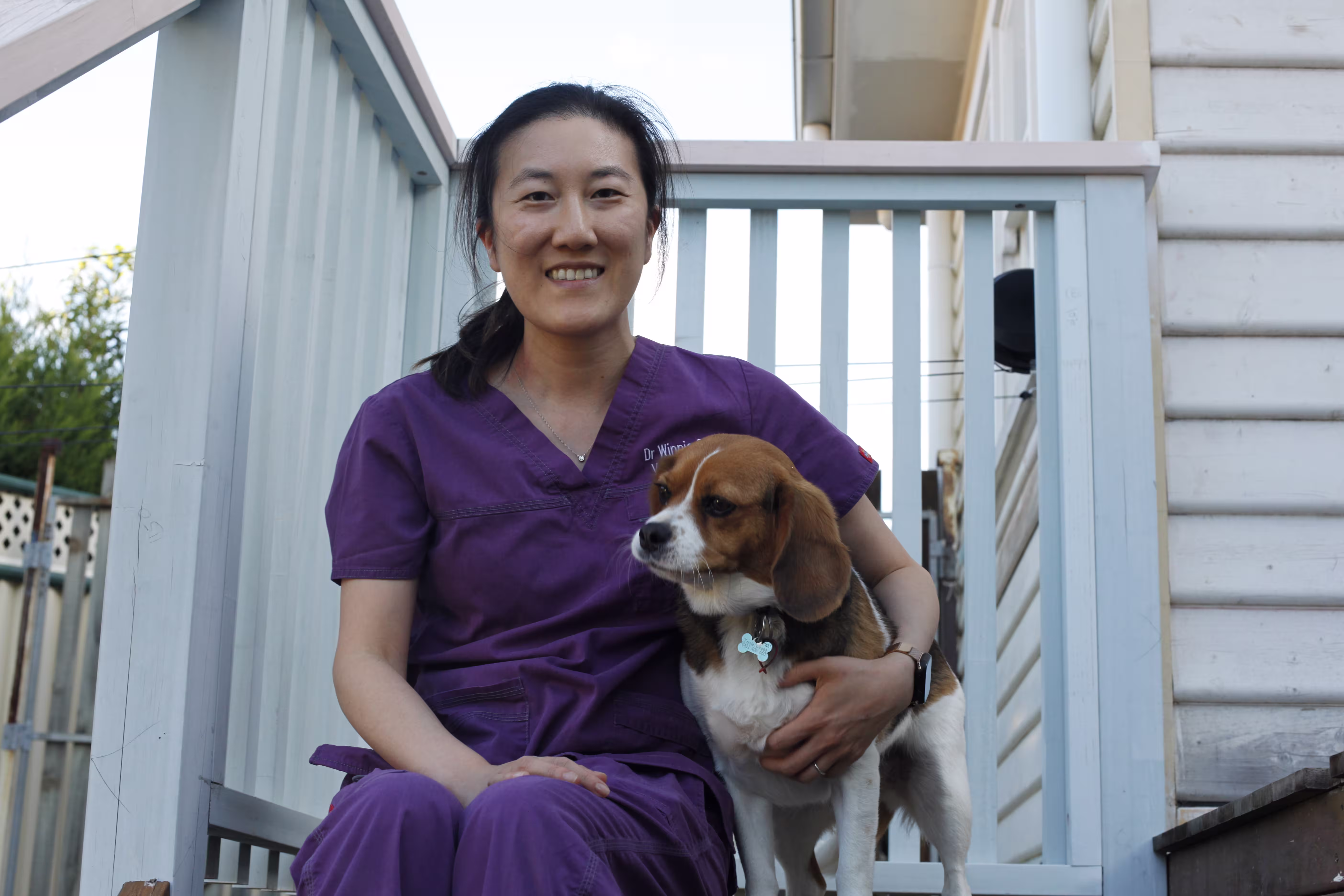 Dr Winnie checking a puppy with a stethoscope during a home vet visit