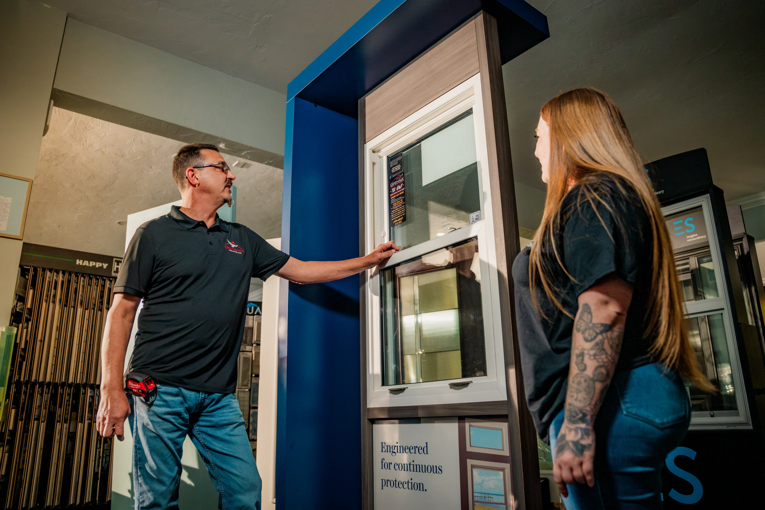 Grayhawk Remodeling staff member showing a window display to a customer