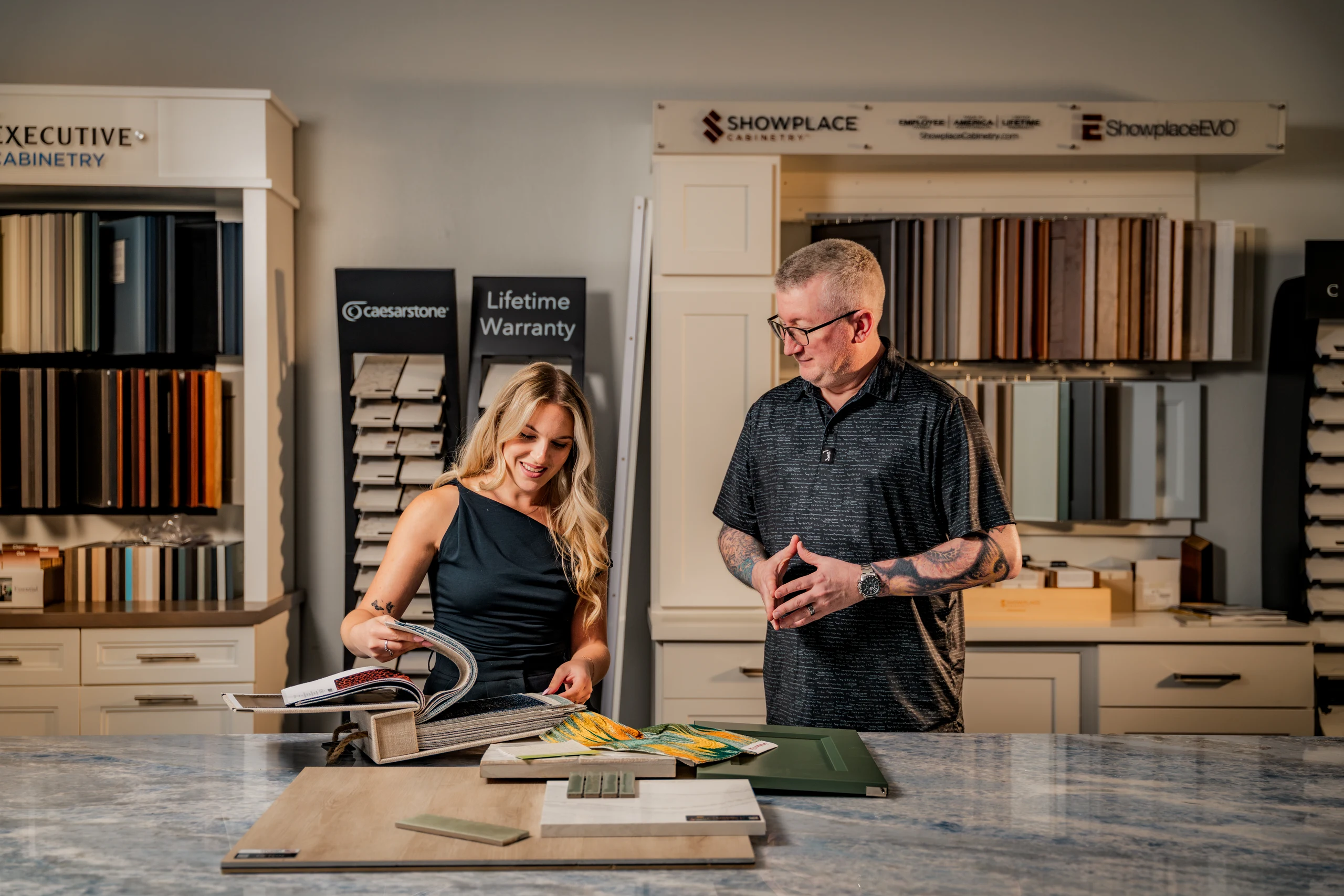 Grayhawk Remodeling designers reviewing material samples in the showroom