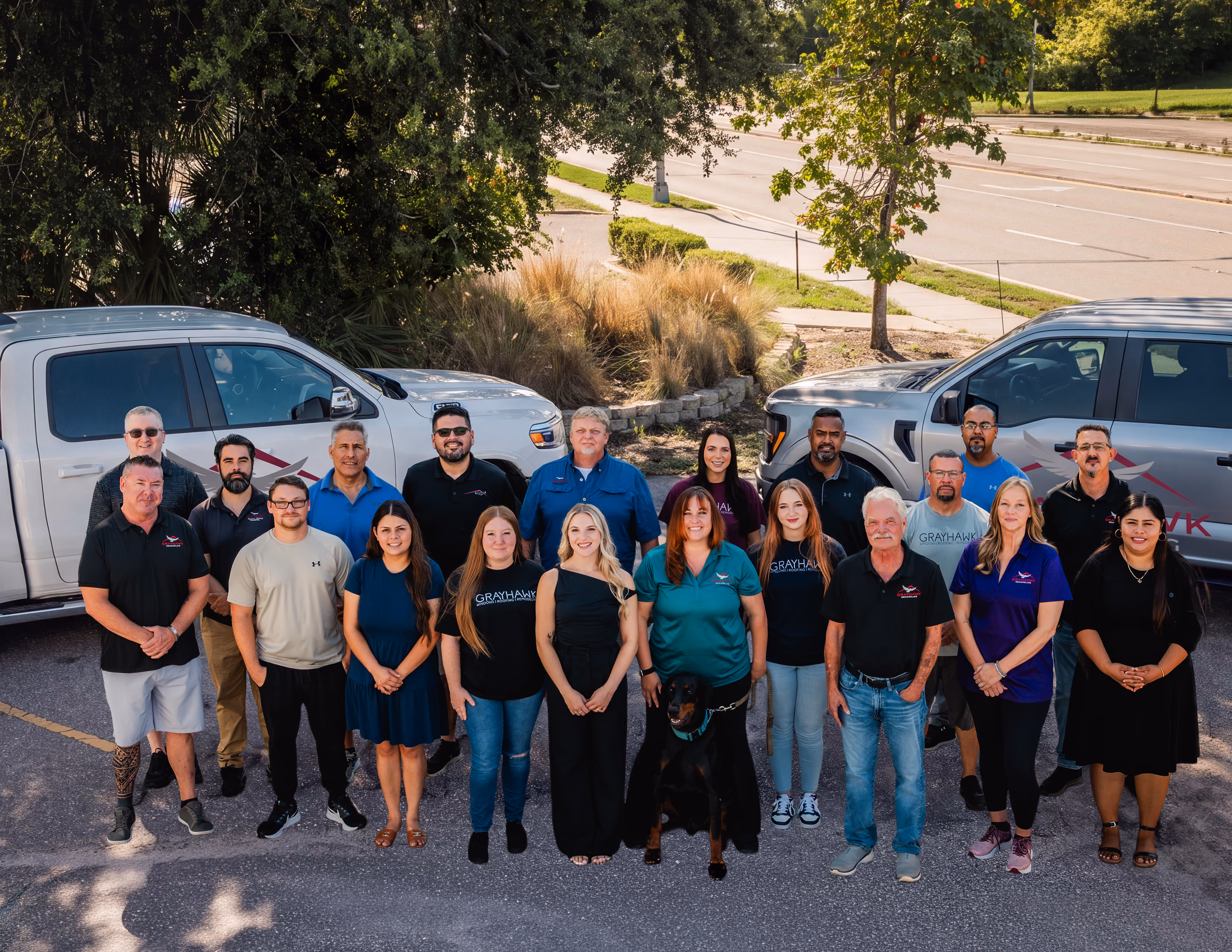 The Grayhawk Remodeling team standing in front of company trucks