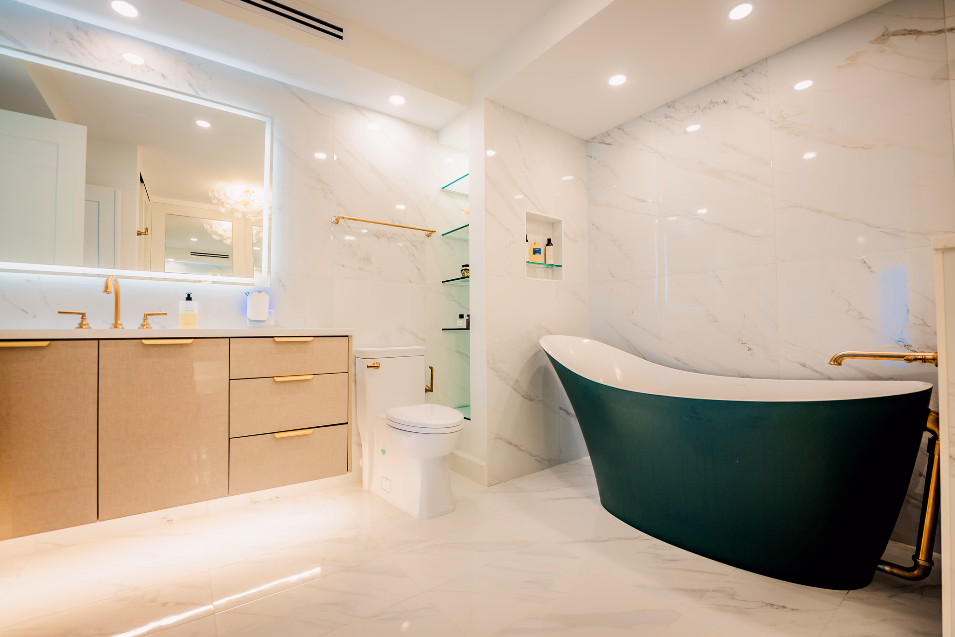 Porcelain tile master bath with freestanding tub and brass fixtures by Grayhawk