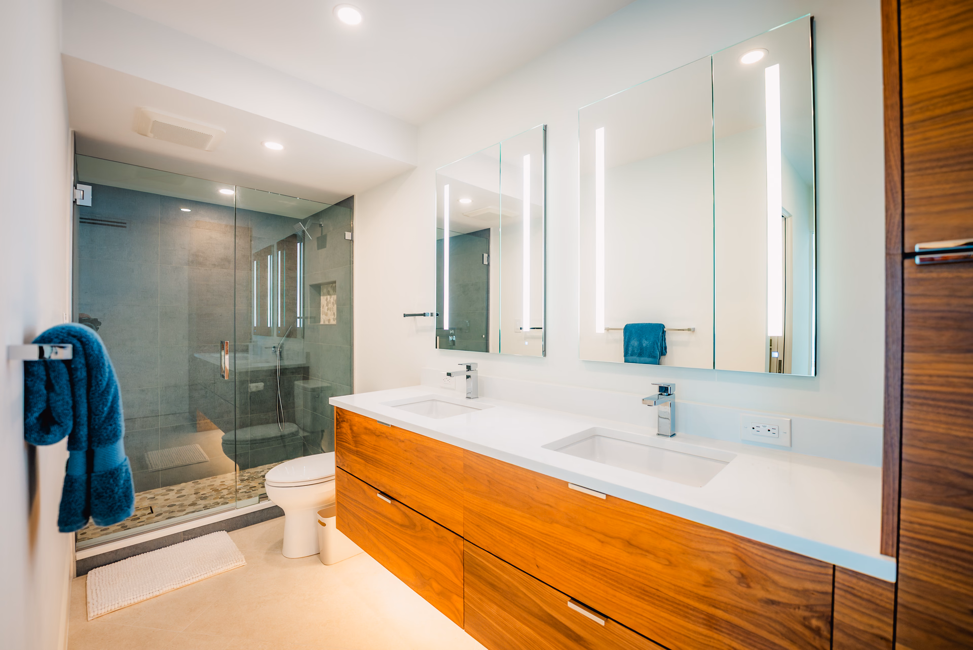 Walnut floating vanity and tiled walk in shower in a Grayhawk bathroom remodel