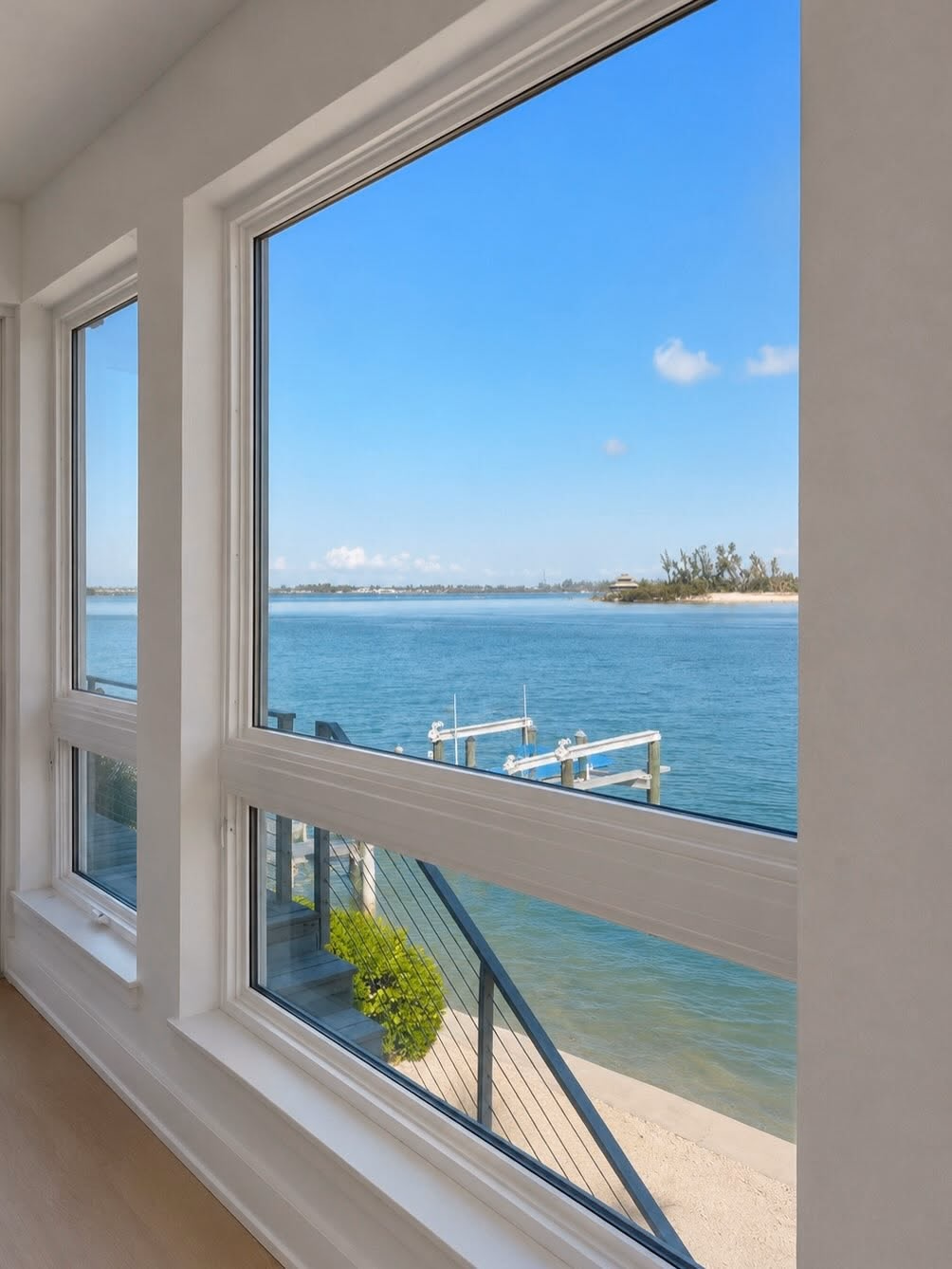 Large picture window overlooking a private dock on the bay
