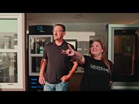 Grayhawk Remodeling staff discussing window displays in the showroom