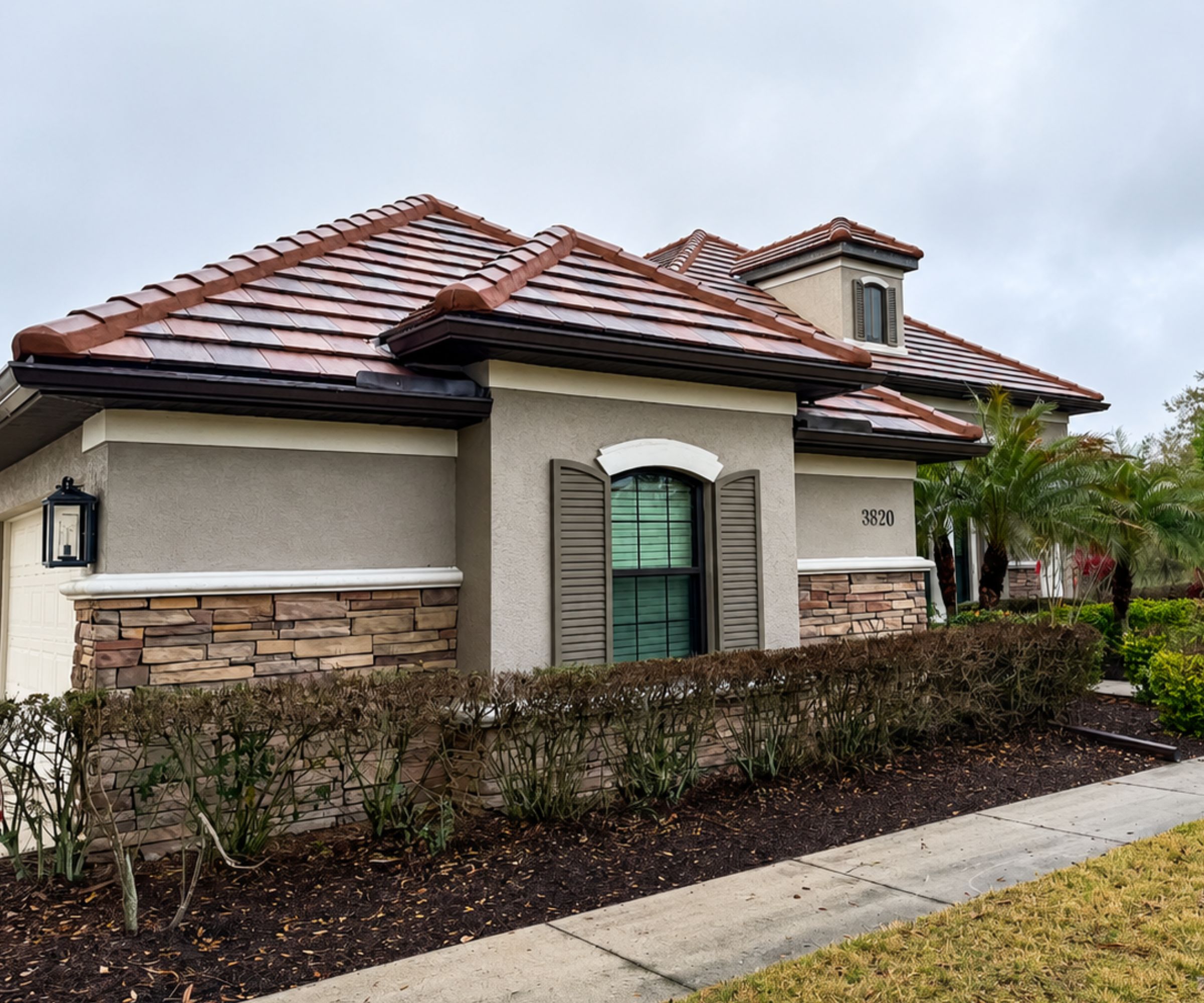Florida home with stone veneer, stucco and a barrel tile roof