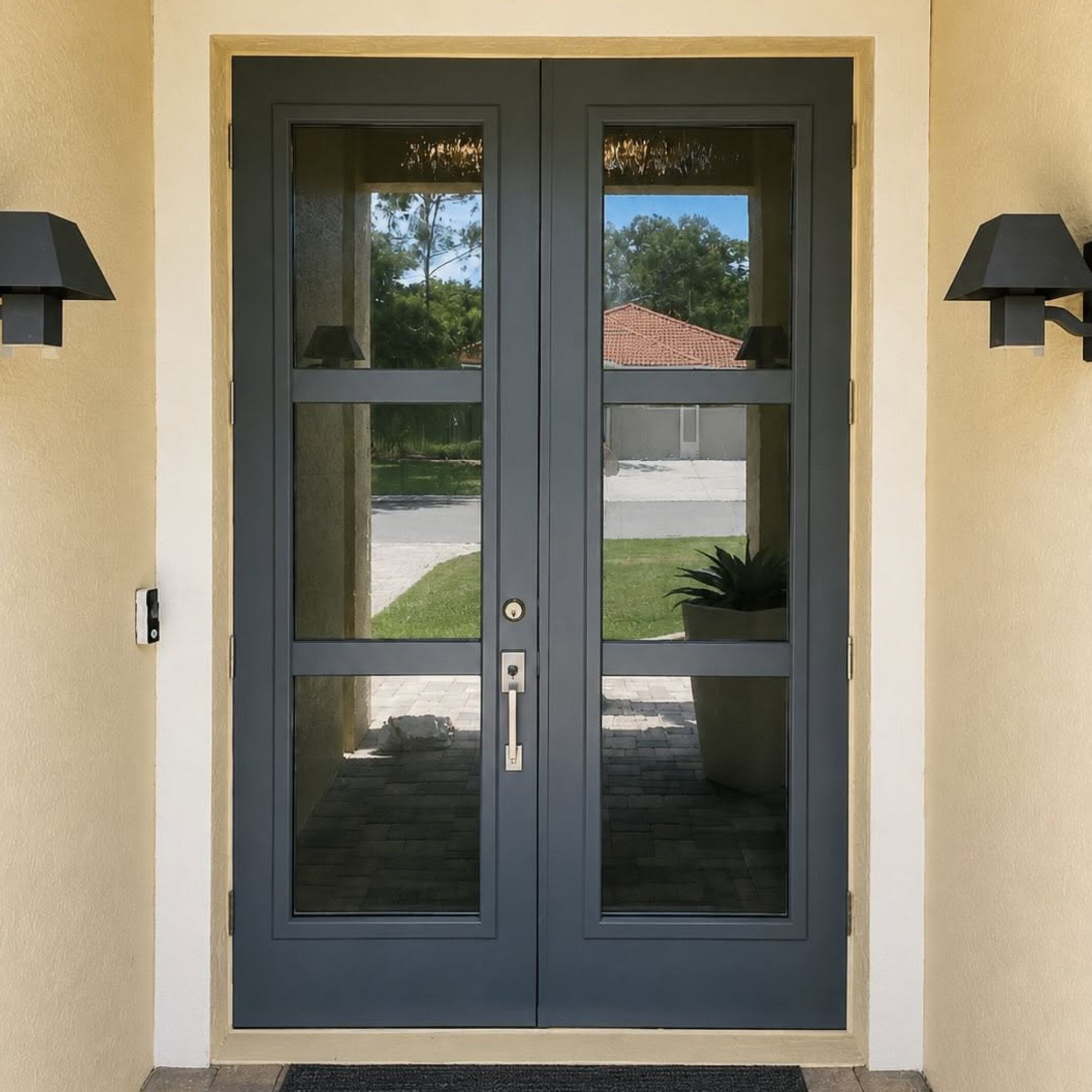 Dark gray double entry doors with full-length glass panels and sconce lighting