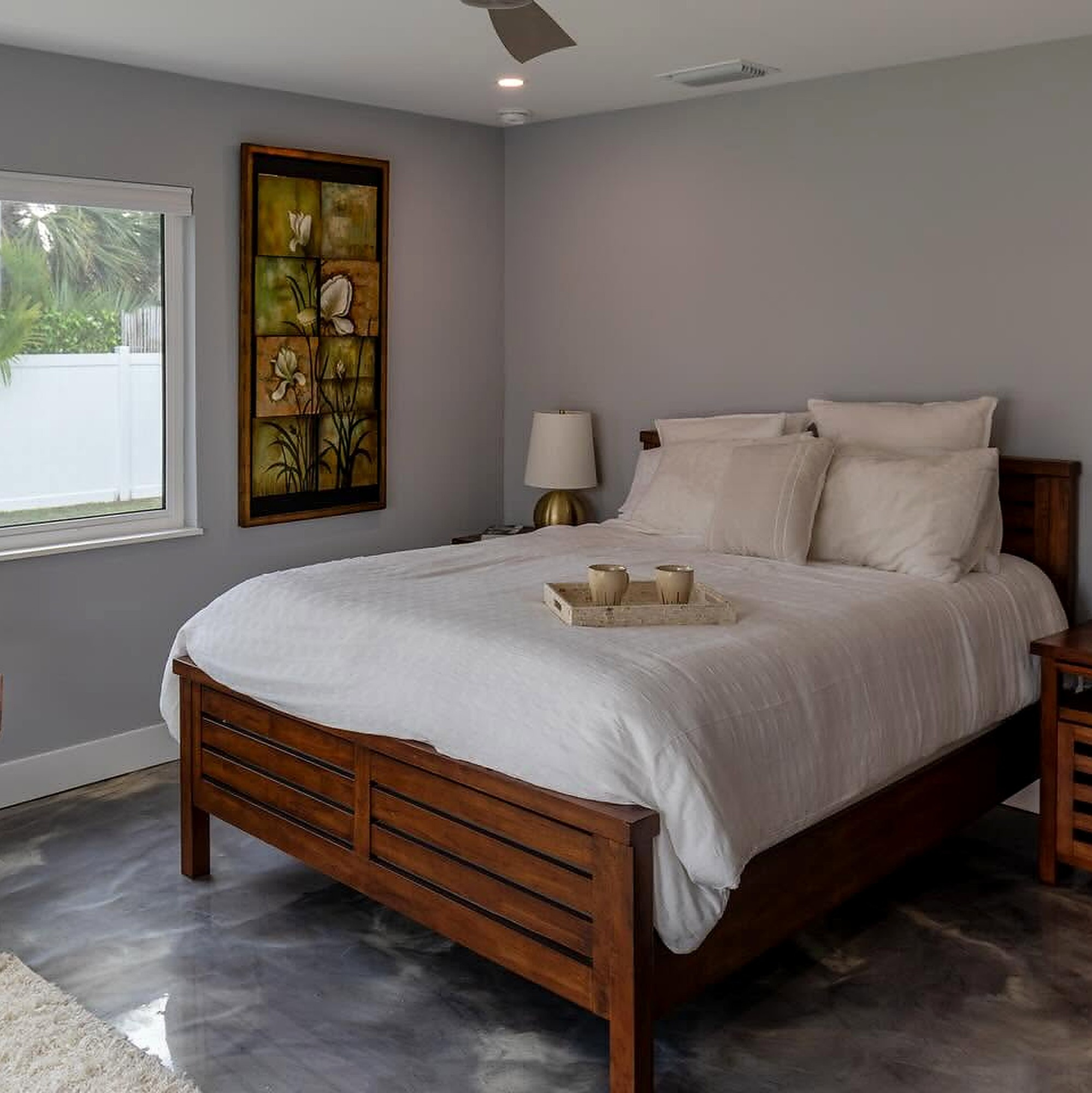 Bedroom addition with a wood bed frame and a new window