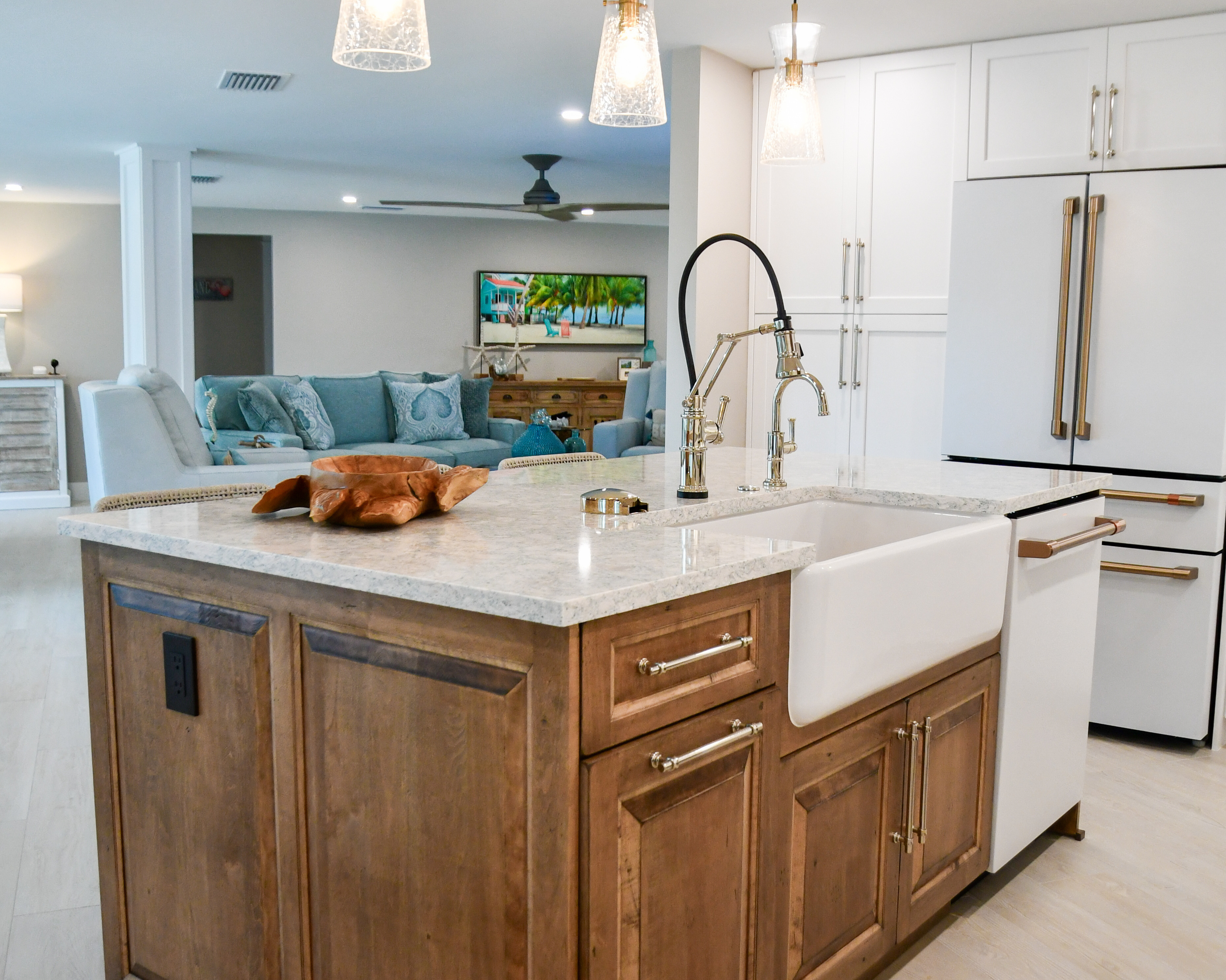 Kitchen island with a wood base, farmhouse sink and quartz countertop