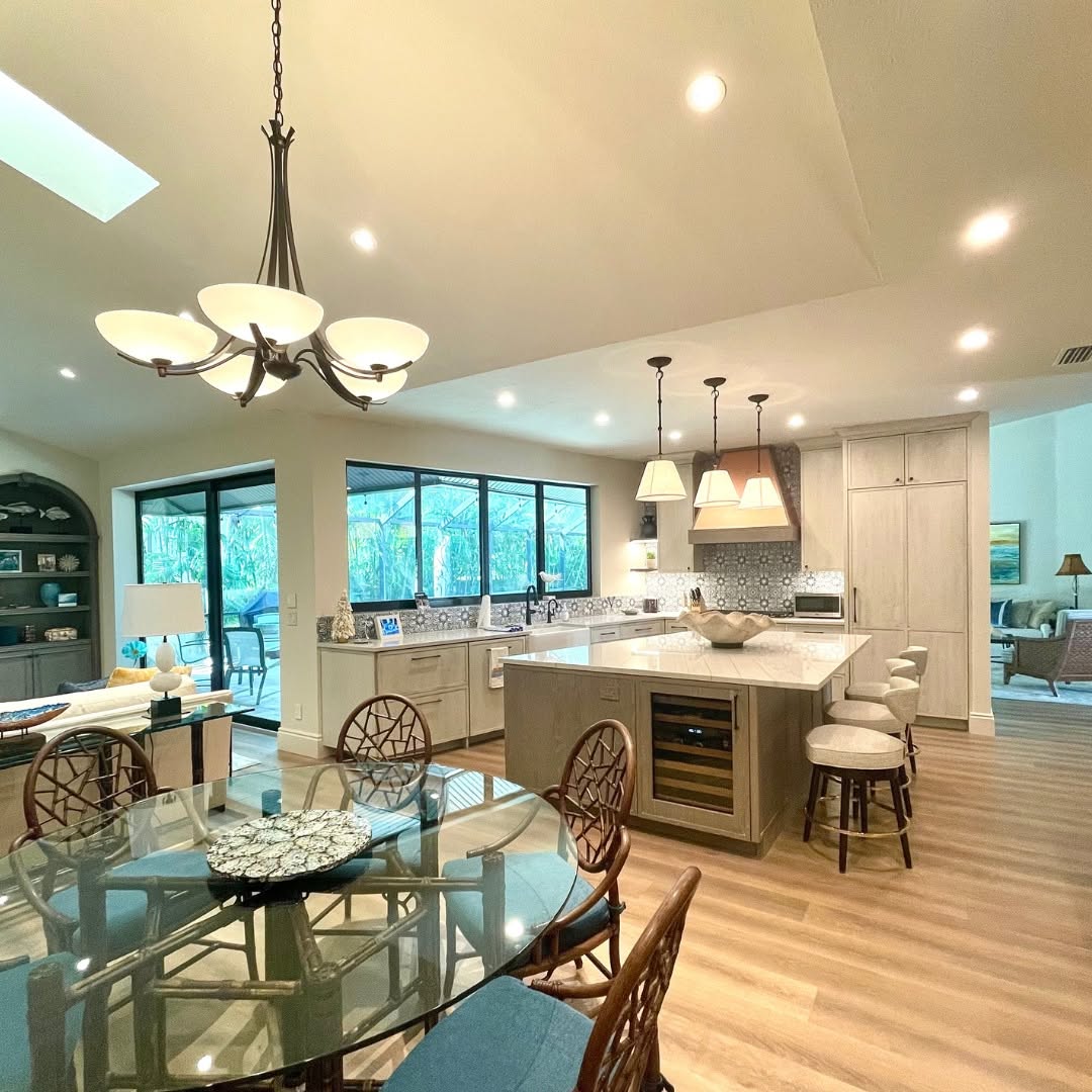 Open-concept kitchen and dining area with an island and skylight
