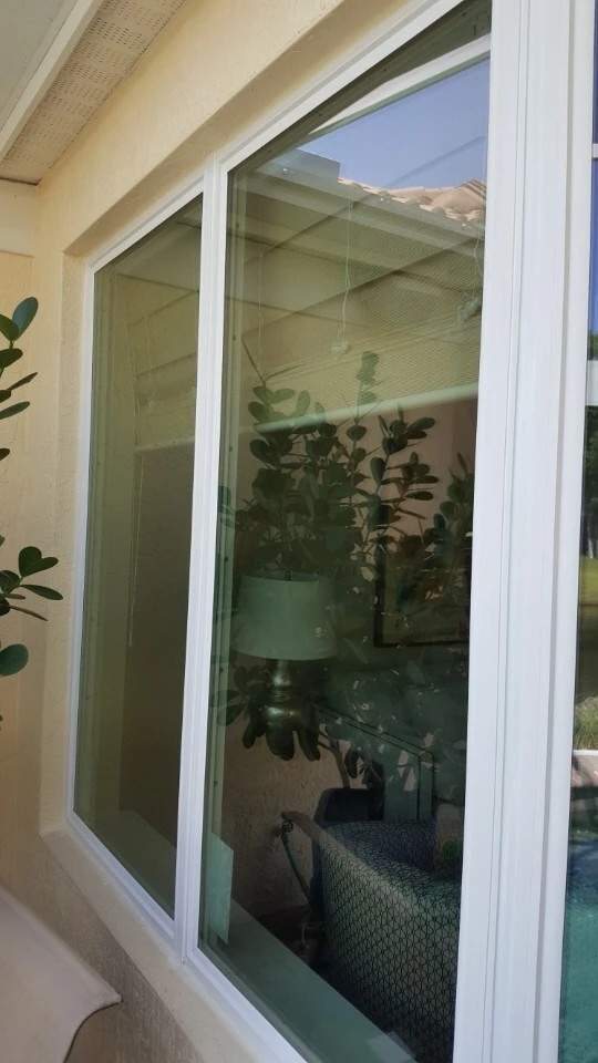 New white-framed impact window on a home exterior