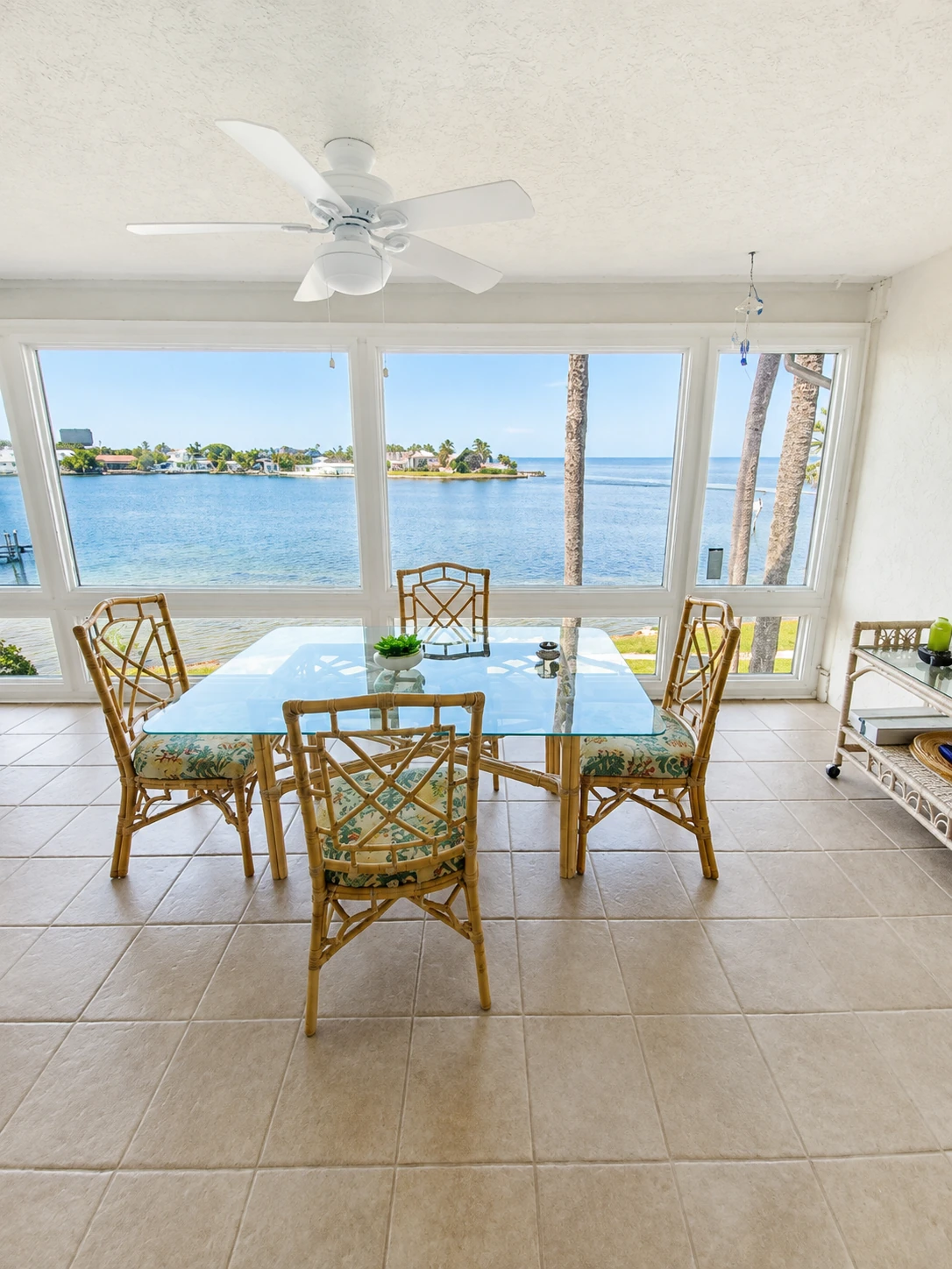 Dining area with wraparound picture windows overlooking the bay