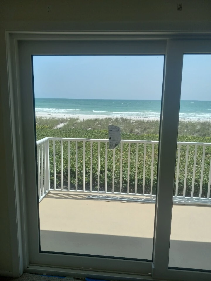 New sliding glass door with a direct view of the beach and Gulf of Mexico