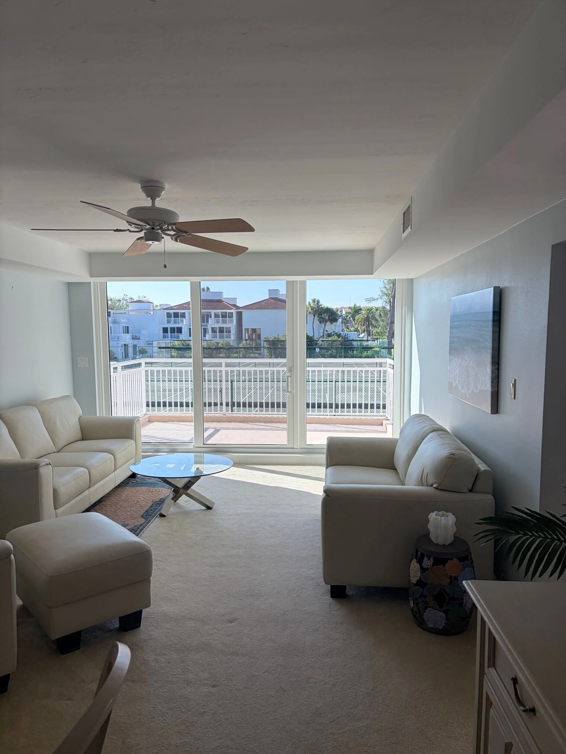 Remodeled condo living room with sliding glass doors opening to a balcony