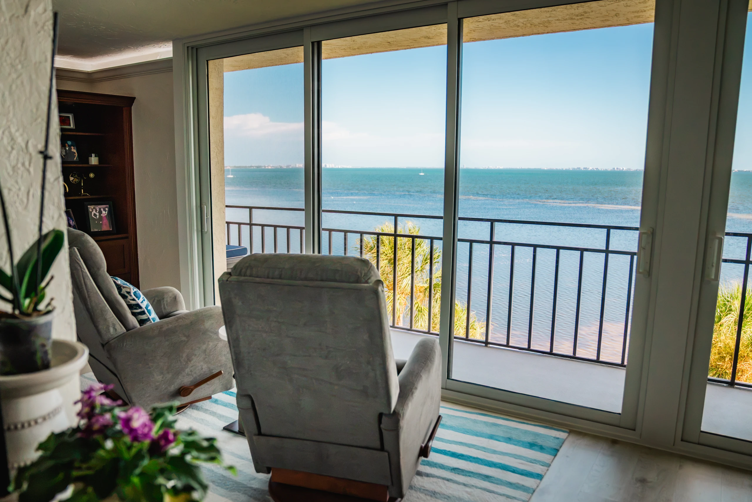 Sliding glass doors opening to a balcony with wide bay views