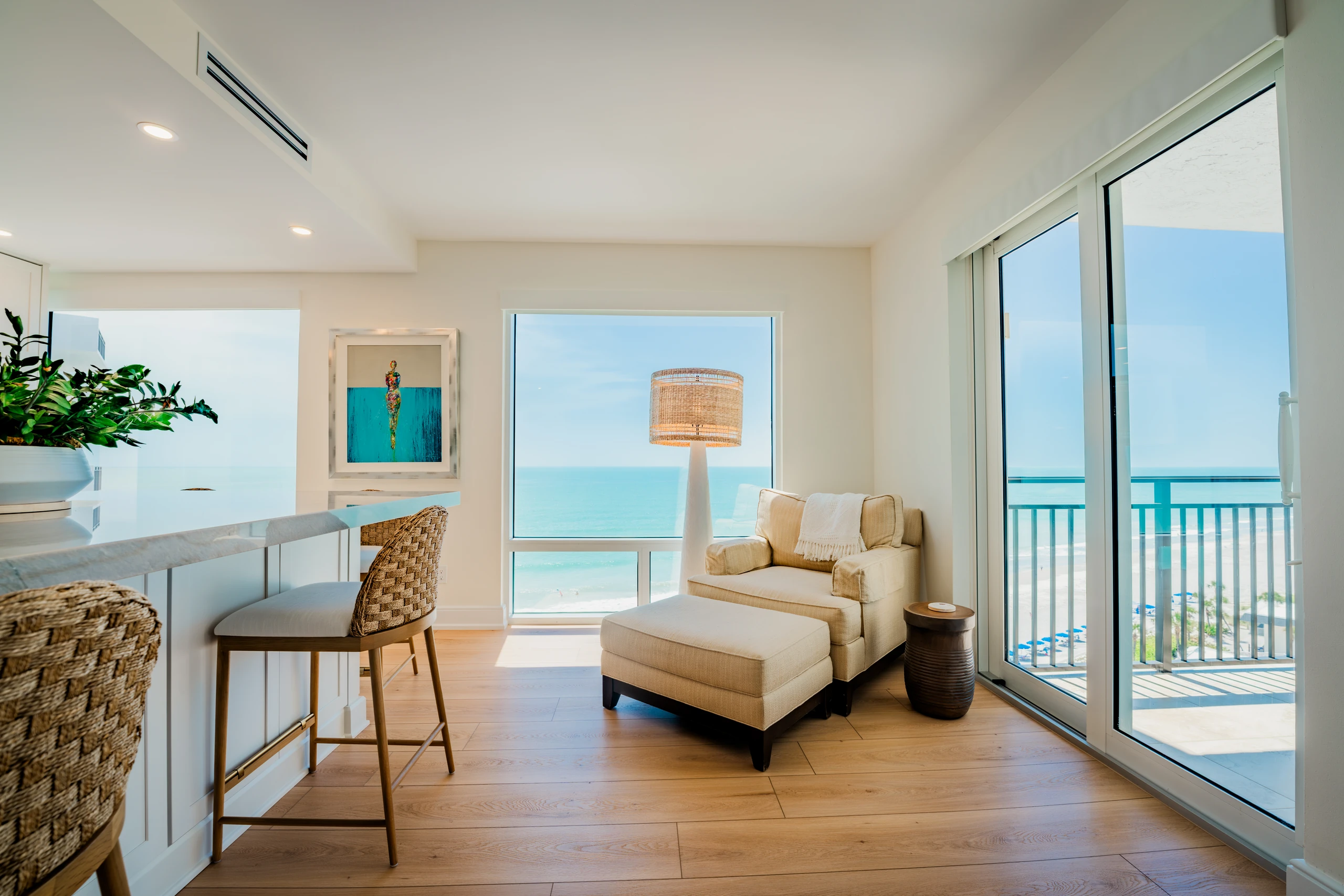 Beachfront living area with sliding glass doors and a counter overlooking the Gulf