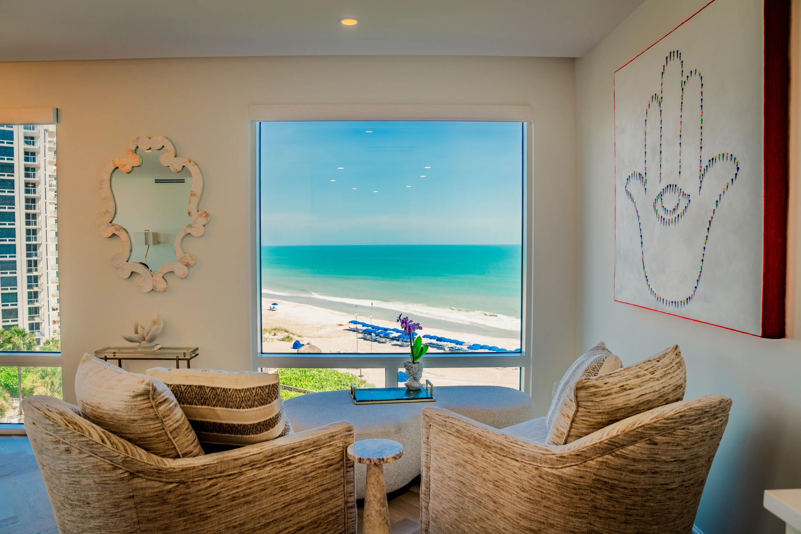 Living room with a large picture window overlooking the beach and Gulf