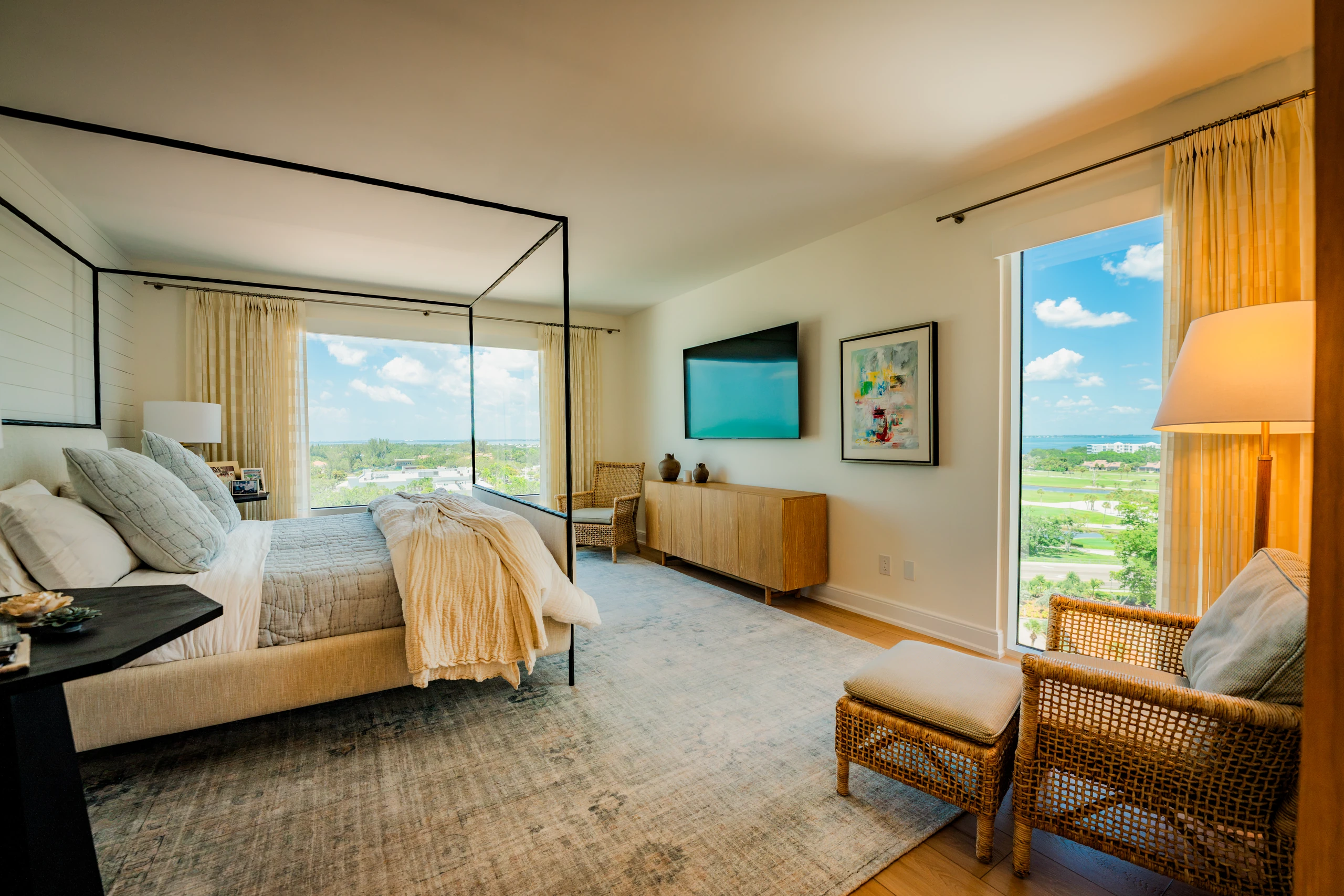 Bedroom addition with a canopy bed and windows overlooking a golf course