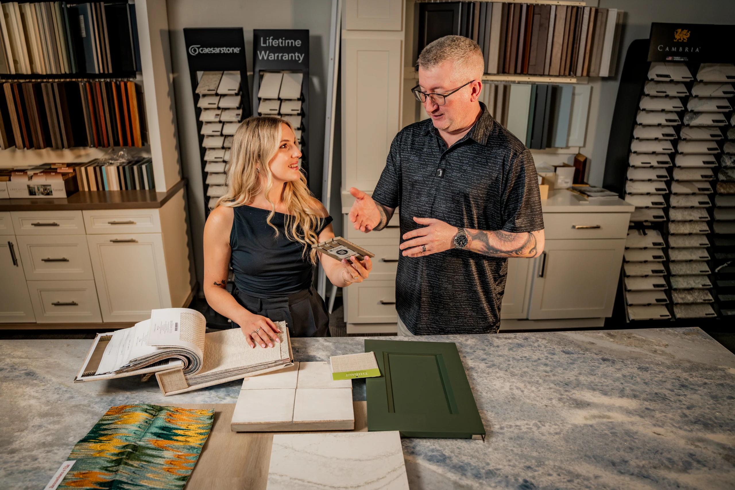 Grayhawk Remodeling designers reviewing tile and cabinet samples in the showroom