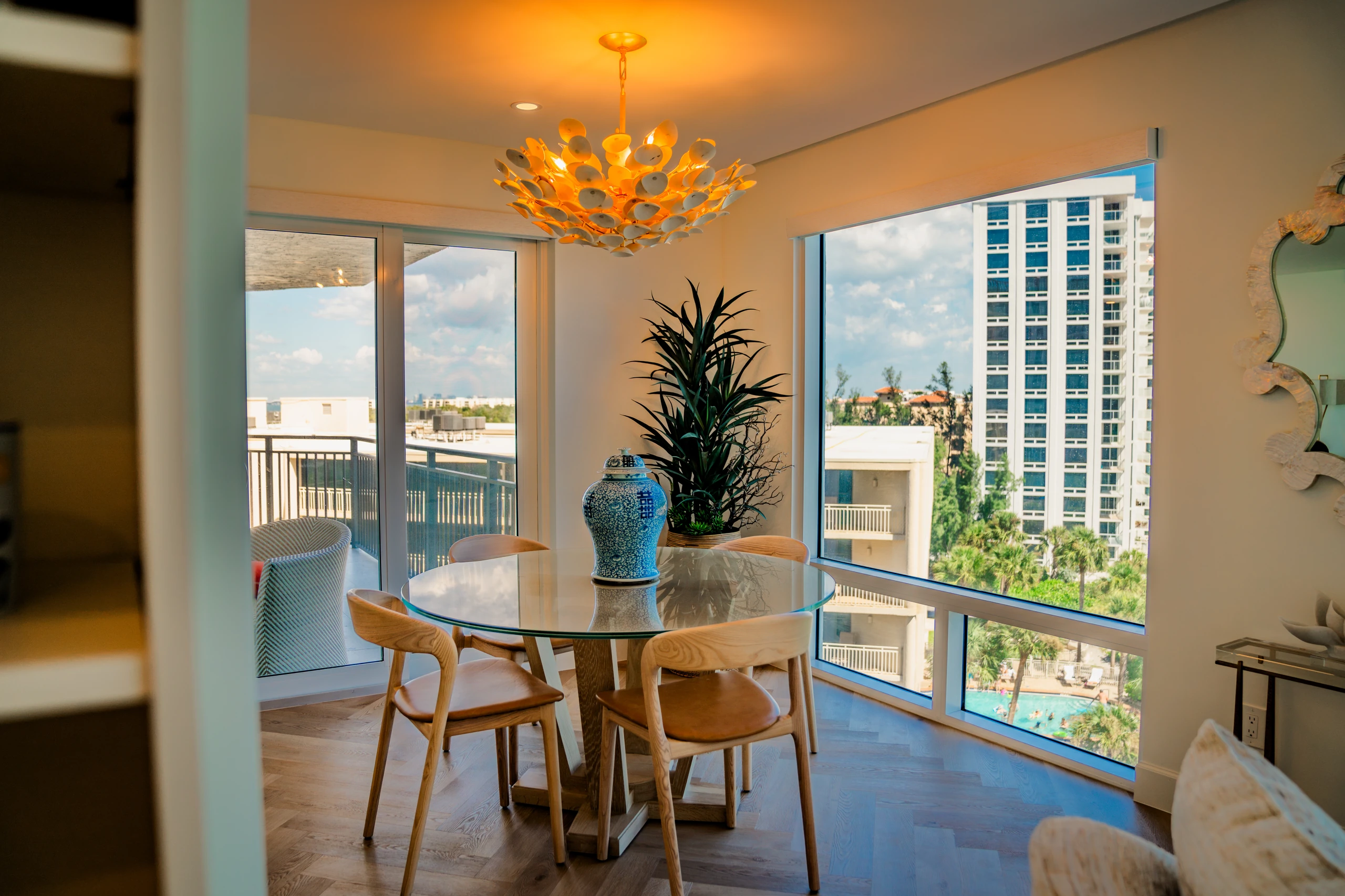 Condo dining area with sliding doors to a balcony overlooking the water