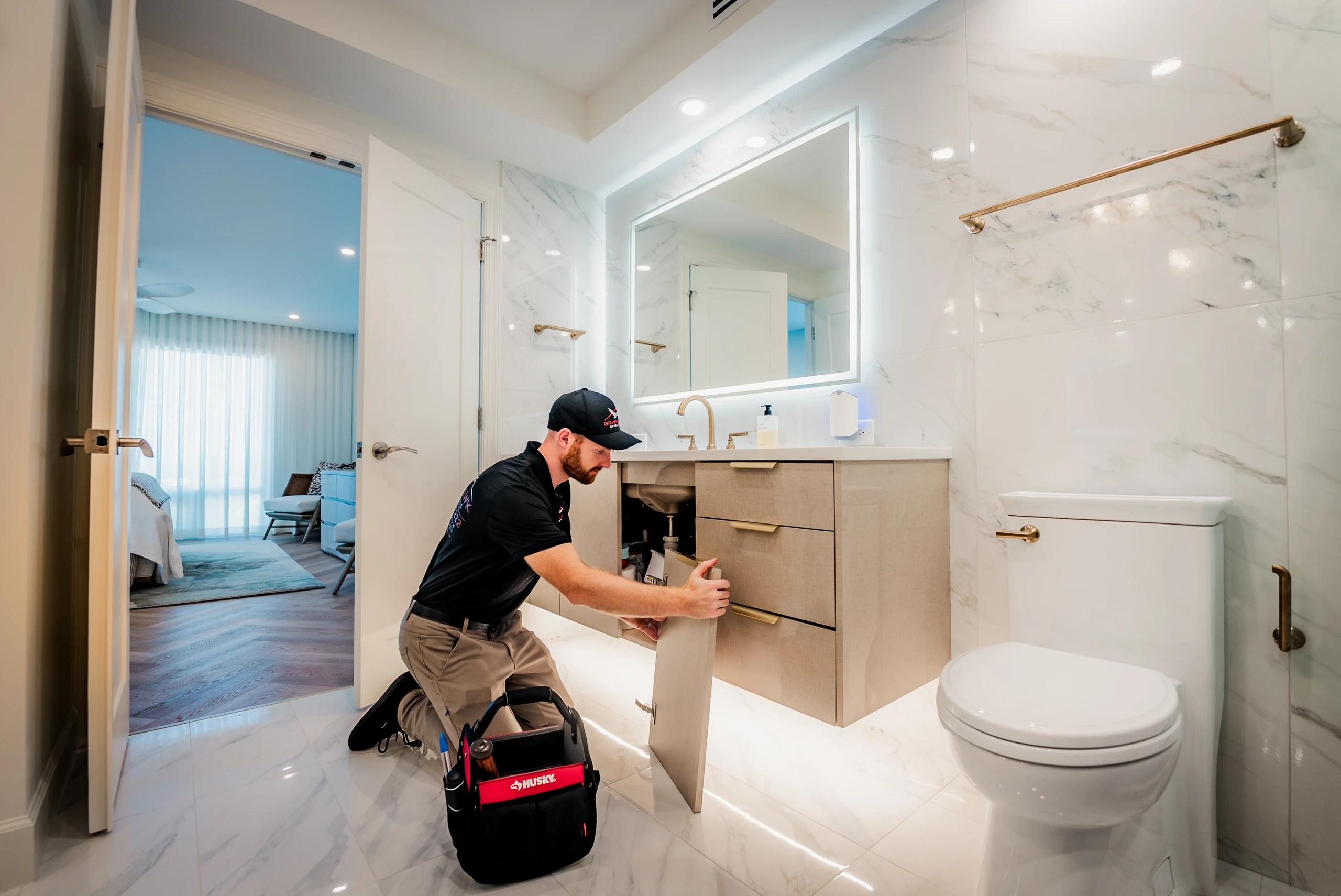 Technician installing a bathroom vanity drawer during a home repair