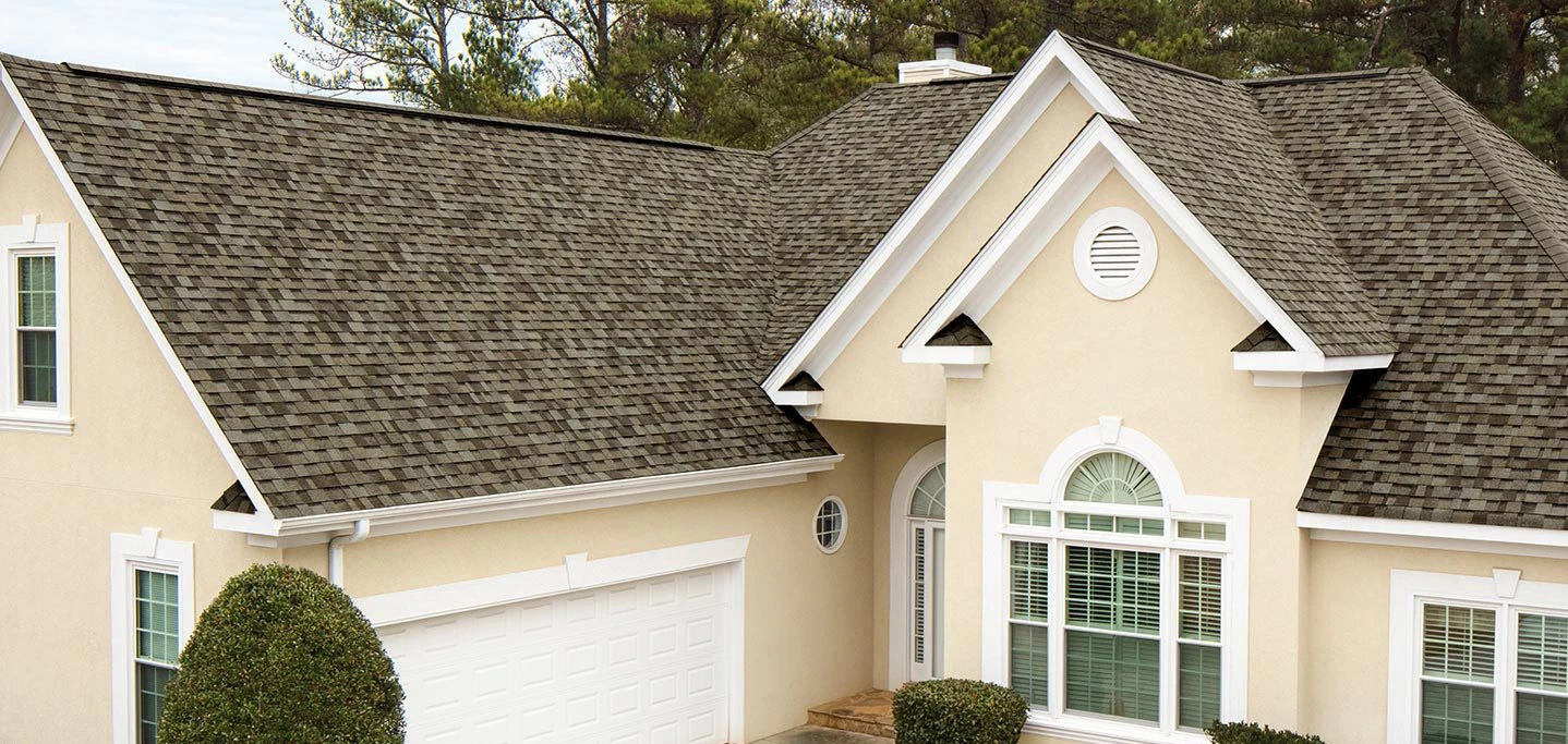 Stucco home with a new architectural asphalt shingle roof and dormer