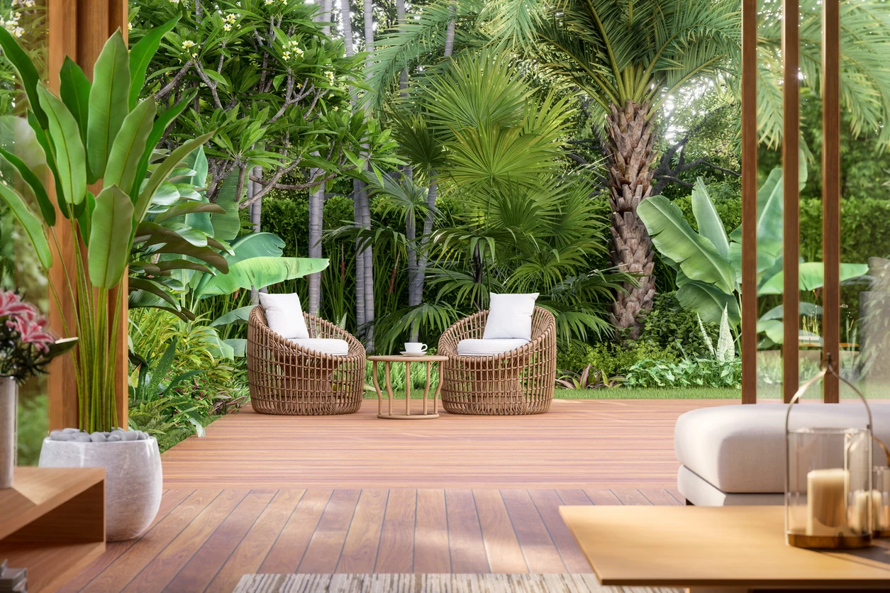 Hardwood deck with woven lounge chairs framed by tropical plants
