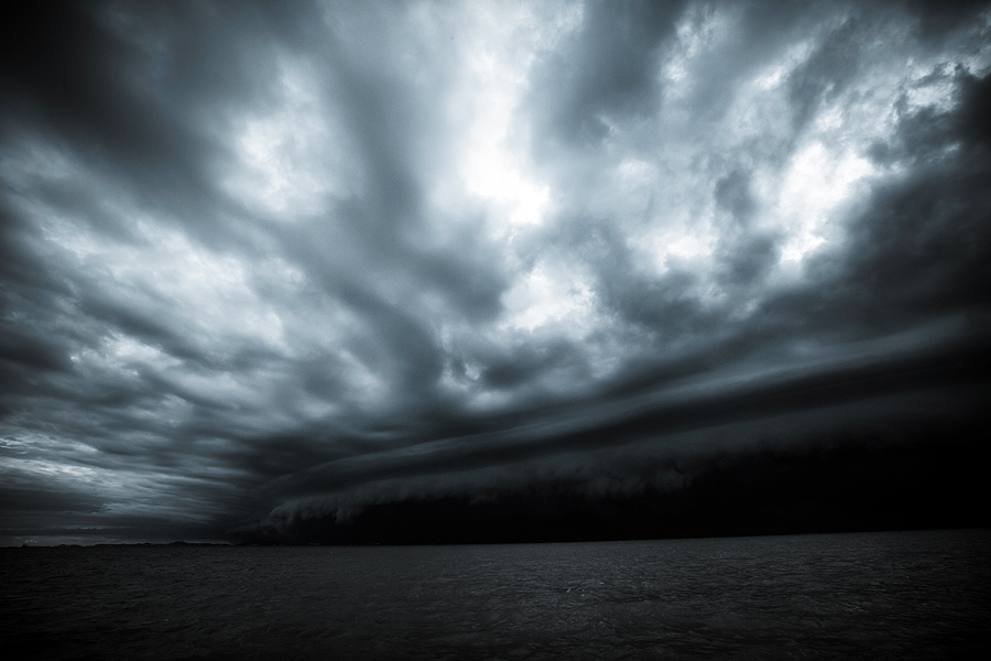 Dark storm clouds rolling in over open water