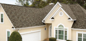Stucco home with a new architectural asphalt shingle roof and arched window