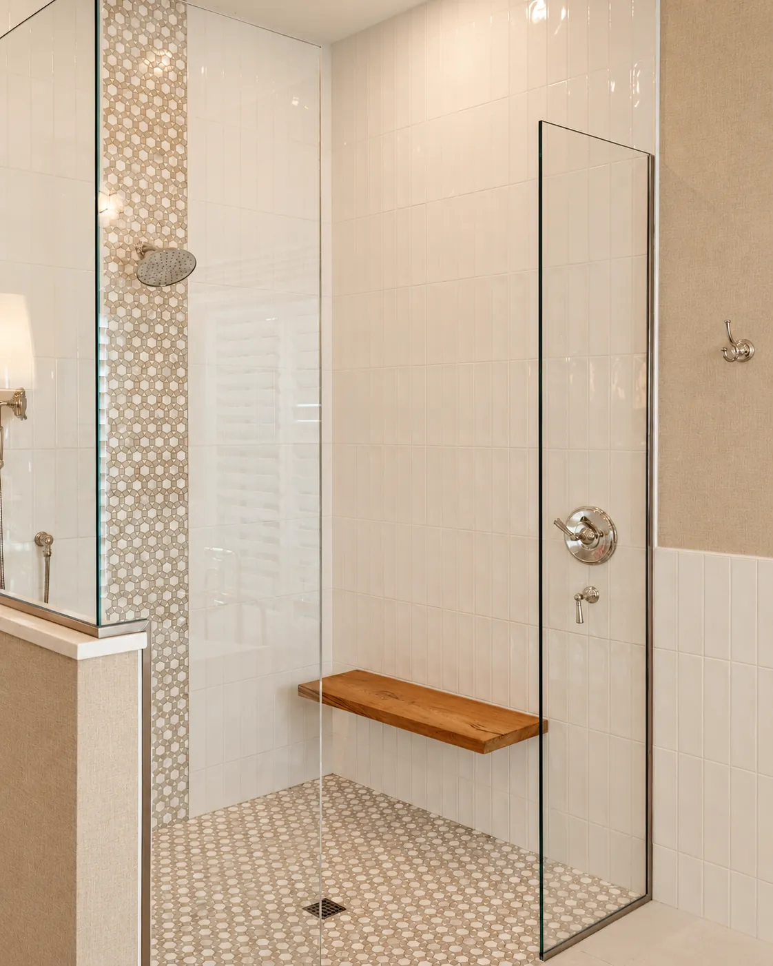 Walk-in shower with white tile, a teak bench and a penny-tile accent stripe
