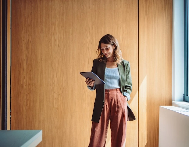 A woman standing and reading documents