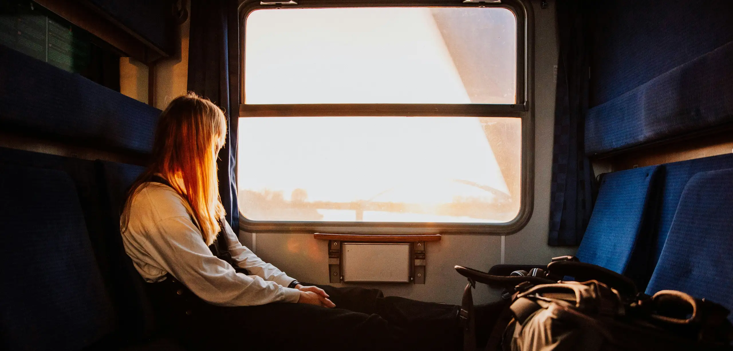 A woman looking out of the window in a train.