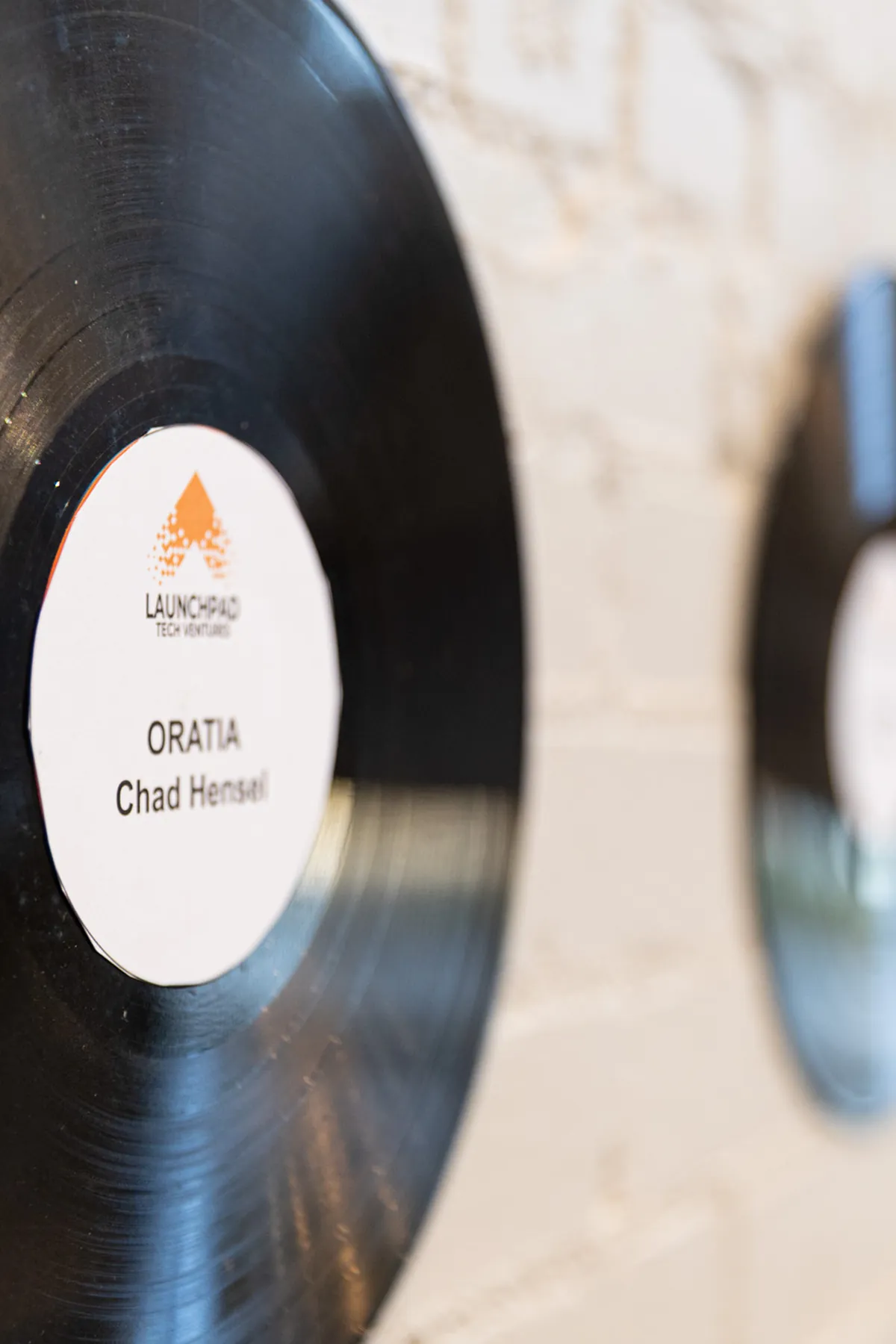 Vinyl records marking graduate companies on the Tech Village wall